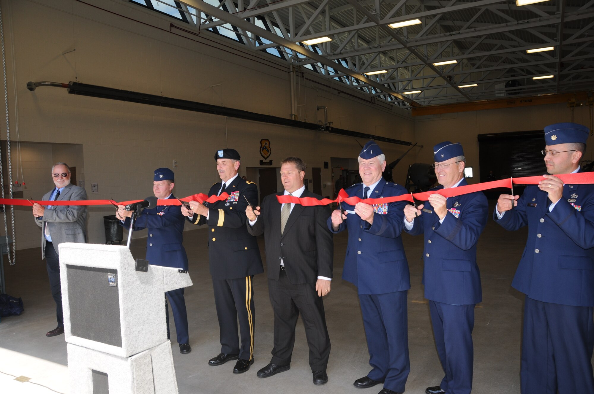 Col. Steve Eggensperger (second from left), 189th Airlift Wing commander, cuts the ceremonial ribbon May 15, 2011, for the new 189th AW engine shop at Little Rock Air Force Base, Ark. With Colonel Eggensperger are (from left) Jimmy Rowe, Wilkins Construction Inc. project superintendent; Maj. Gen. William Wofford, the Arkansas National Guard Adjutant General; Edwin Cromwell Levy with Cromwell’s Architects and Engineers; Brig. Gen. Riley Porter, Arkansas National Air Control Group commander; Brig. Gen. Dwight Balch, Arkansas Air National Guard commander; and Maj. Paul Jara, 189th Civil Engineer Squadron commander. (U.S. Air Force photo/Master Sgt. Dianna Seerey)