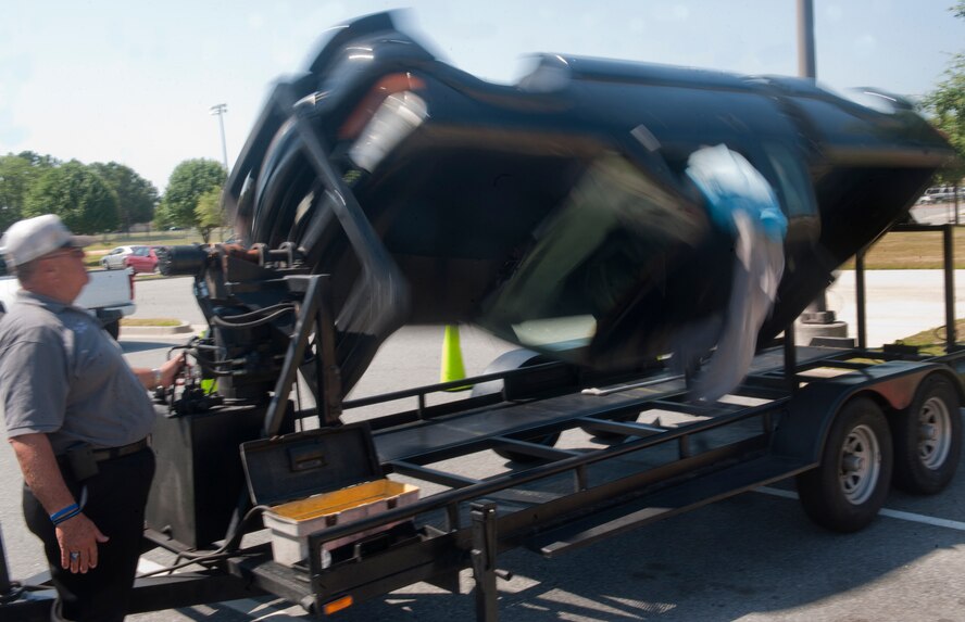 William Hires, Coastal Area Traffic Enforcement Network coordinator, shows the importance of wearing a seatbelt by simulating a vehicle wreck with a roll-over simulator at Moody Air Force Base, Ga., May 20. When riding in a vehicle, a seatbelt can be the difference between life and death. (U.S Air Force photo/Airman 1st Class Douglas Ellis)(RELEASED)
