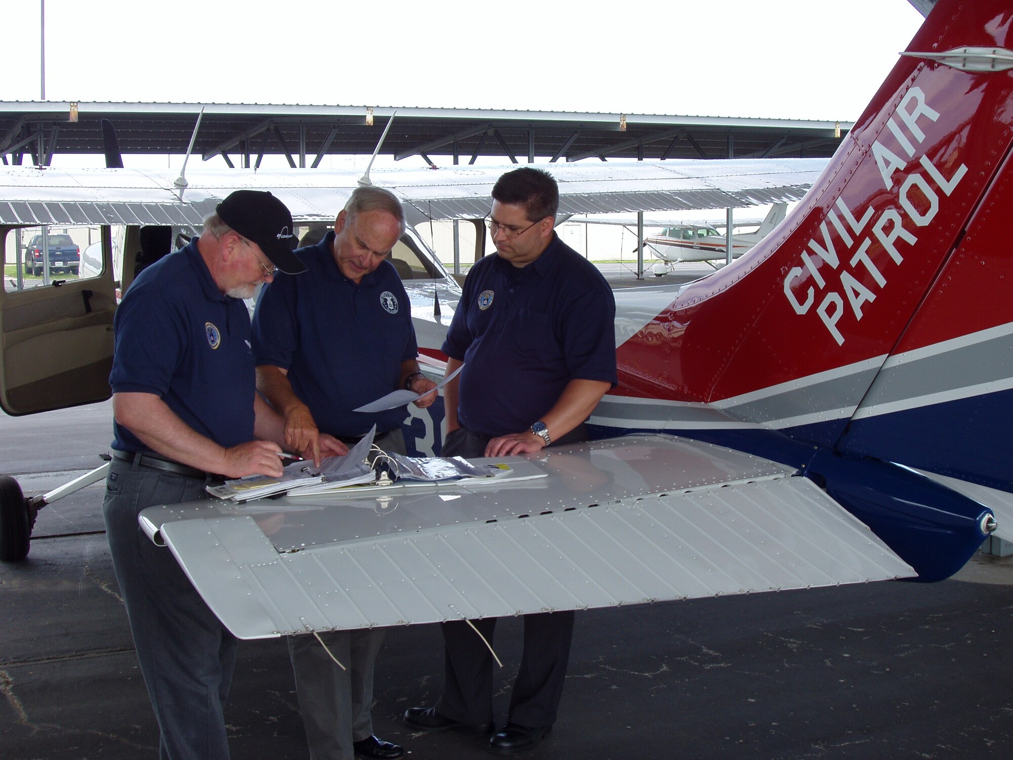 Members of the Missouri Wing prepare for another sortie on the third day of the exercise: (from left) Capts. Jack Gray, Gil Franck, and Mike Schaefer.  Gray and Schaefer are members of the Mid Rivers Senior Squadron while Franck is a member of the Gateway Senior Squadron. (Civil Air Patrol photo by Lt. Col. David A. Miller)