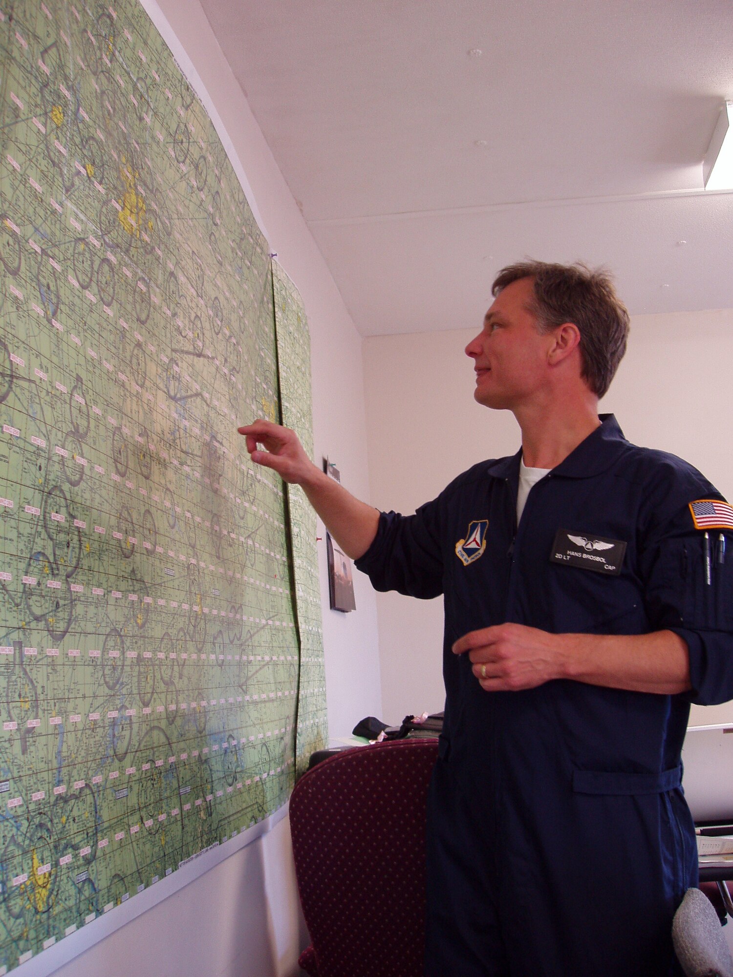 2nd Lt. Hans Brosbol, Gateway Senior Squadron, reviews air charts prior to flying "high bird" on day two of the exercise. (Civil Air Patrol photo by Lt. Col. David A. Miller)