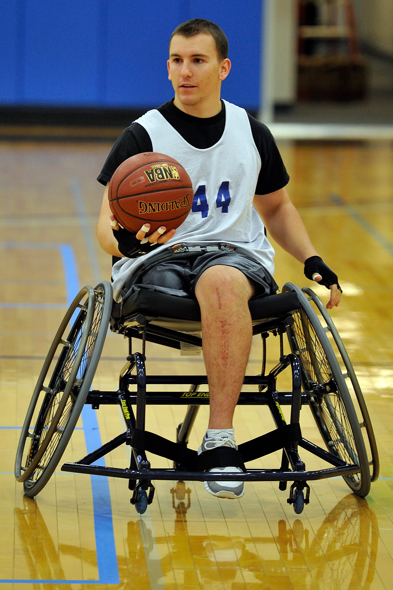 Air Force ROTC Cadet Matthew Pirrello, a member of the Ai r Force wheelchair basketball team, heads up the court during a practice game May 12, 2011, in the Air Force Academy base gym. Cadet Pirrello lost his right leg and broke his left in a parachuting accident at the Academy last June. He and other Air Force wounded warriors are participating in the 2011 Warrior Games. (U.S. Air Force photo/Bill Evans)