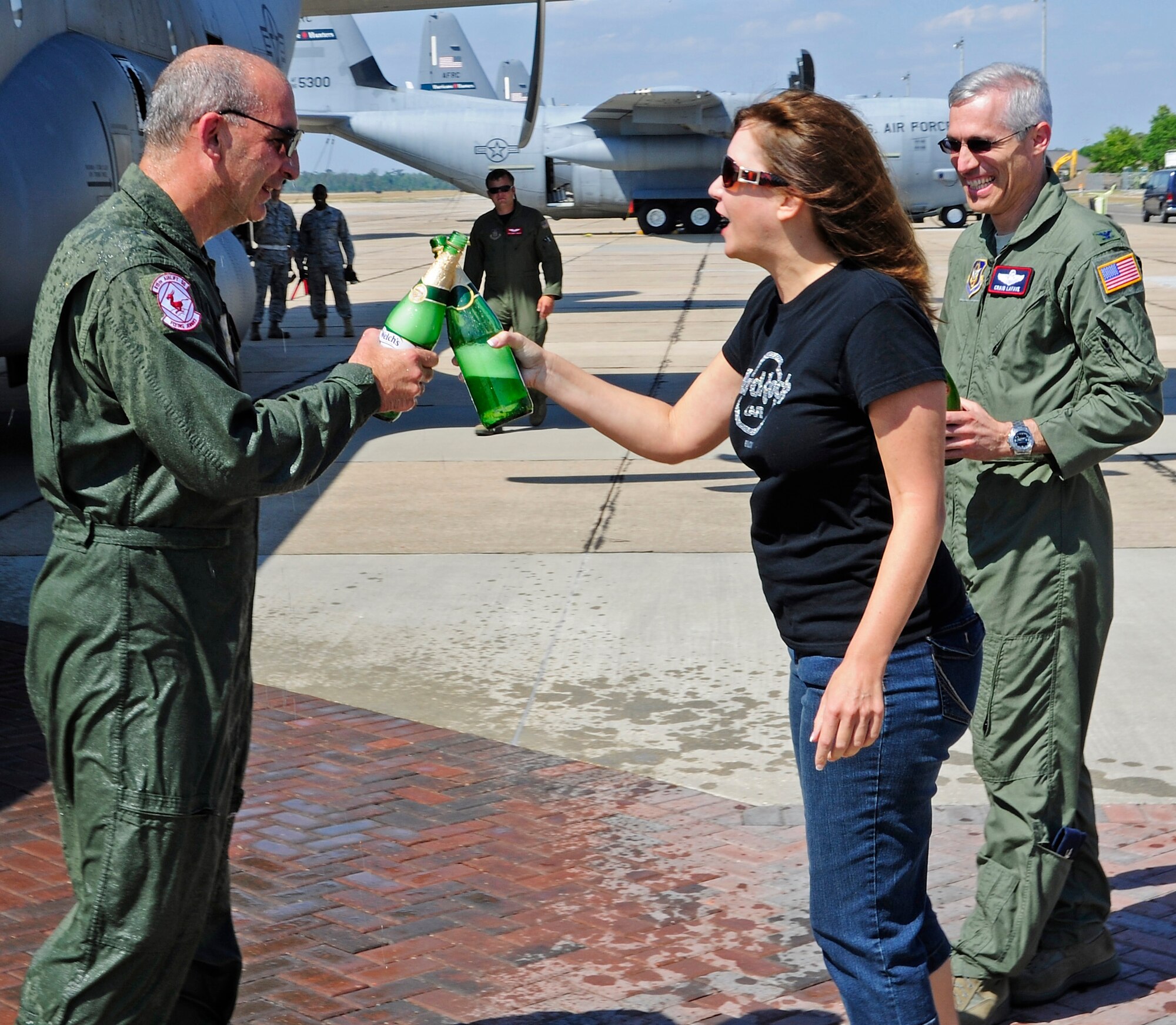 Brig. Gen. James Muscatell, 403rd Wing commander, toasts his wife, Nancy with sparkling grape juice after he finished his last flight in the Air Force May 6.  General Muscatell flew a group of Mississippi Gulf Coast residents home from the 403rd Wing's annual Civic Leader Tour.  The tour departed May 5 from Keesler Air Force Base, Miss., where General Muscatell and the civic leaders toured Niagara Falls Air Reserve Station, N. Y.    (U.S. Air Force photo by Tech. Sgt. Tanya King)