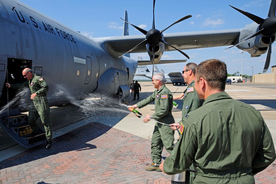 Col. Craig LaFave, 403rd Wing vice commander, Lt. Col. Dave Price, 53rd Weather Reconnaissance Squadron, and Col. Louis Patriquin, 403rd Operations Group commander, hose down Brig. Gen. James Muscatell, 403rd Wing commander, after he finished his last flight in the Air Force May 6.  General Muscatell flew a group of Mississippi Gulf Coast residents home from the 403rd Wing's annual Civic Leader Tour.  The tour departed May 5 from Keesler Air Force Base, Miss., where General Muscatell and the civic leaders toured Niagara Falls Air Reserve Station, N. Y.    (U.S. Air Force photo by Tech. Sgt. Tanya King)