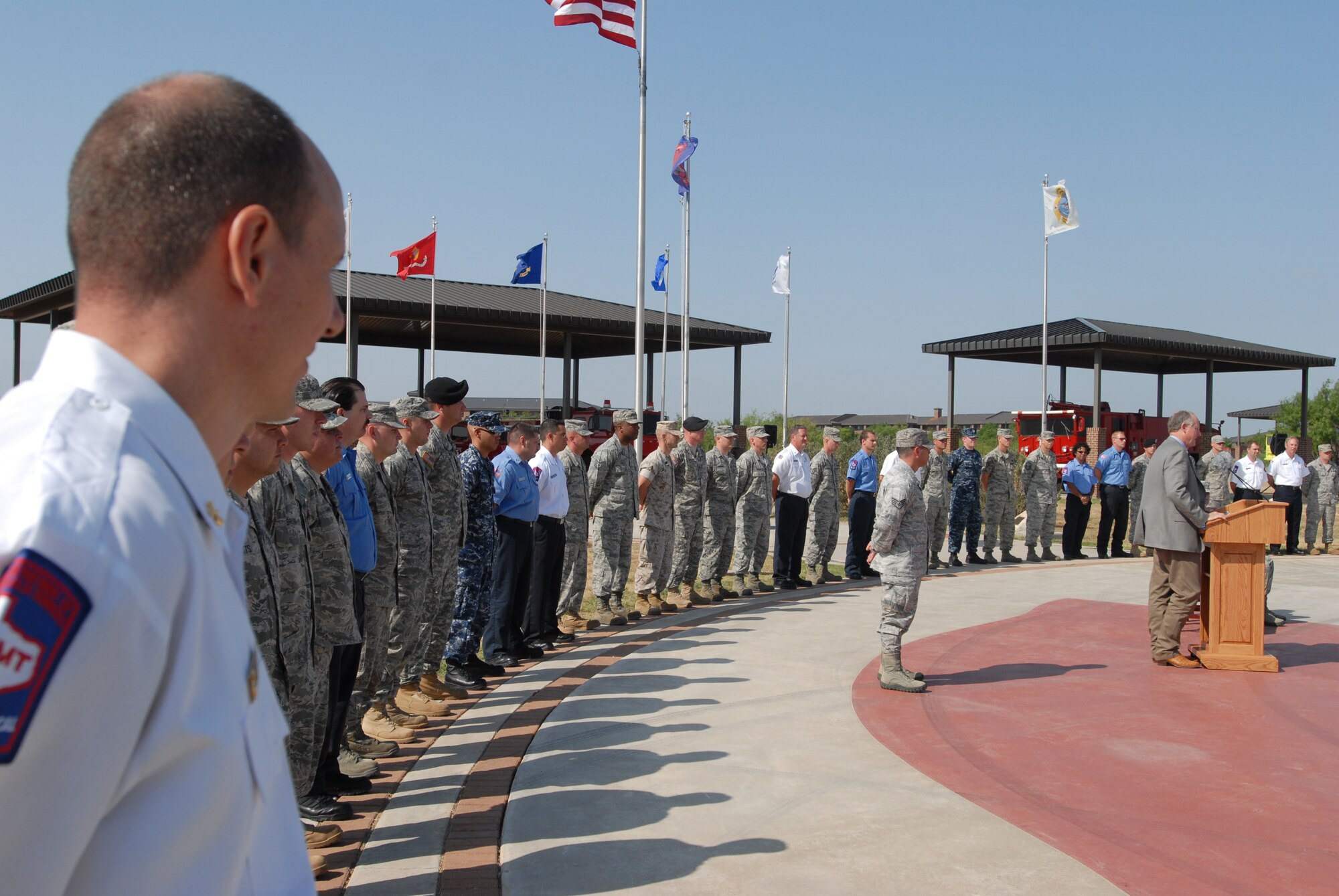 GOODFELLOW AIR FORCE BASE, Texas -- Richard Alter, 17th Civil Engineer Squadron assistant fire chief, watches as Congressman Mike Conaway, 11th District of Texas, speaks at the firefighter award ceremony May 18. Fifty-four Team GoodFellow firefighters received achievement medals for their assistance in extinguishing the Wildcat Fire. (U.S. Air Force photo/Airman 1st Class Michael Smith)