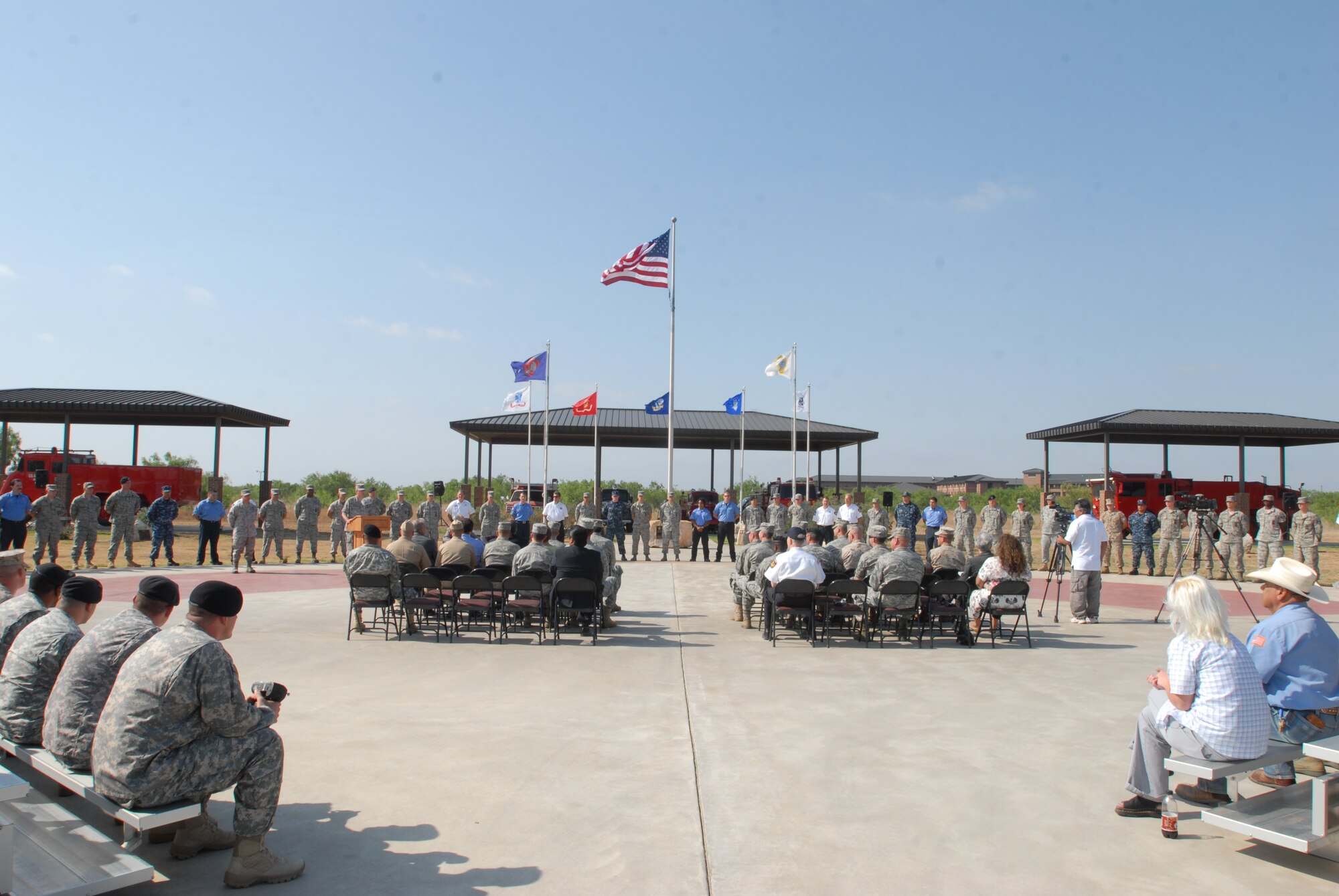 GOODFELLOW AIR FORCE BASE, Texas – Team Goodfellow firefighters come together May 18 as their families watch from the crowd before being presented achievement medals for their work against the Wildcat Fire. (U.S. Air Force photo/Airman 1st Class Michael Smith)