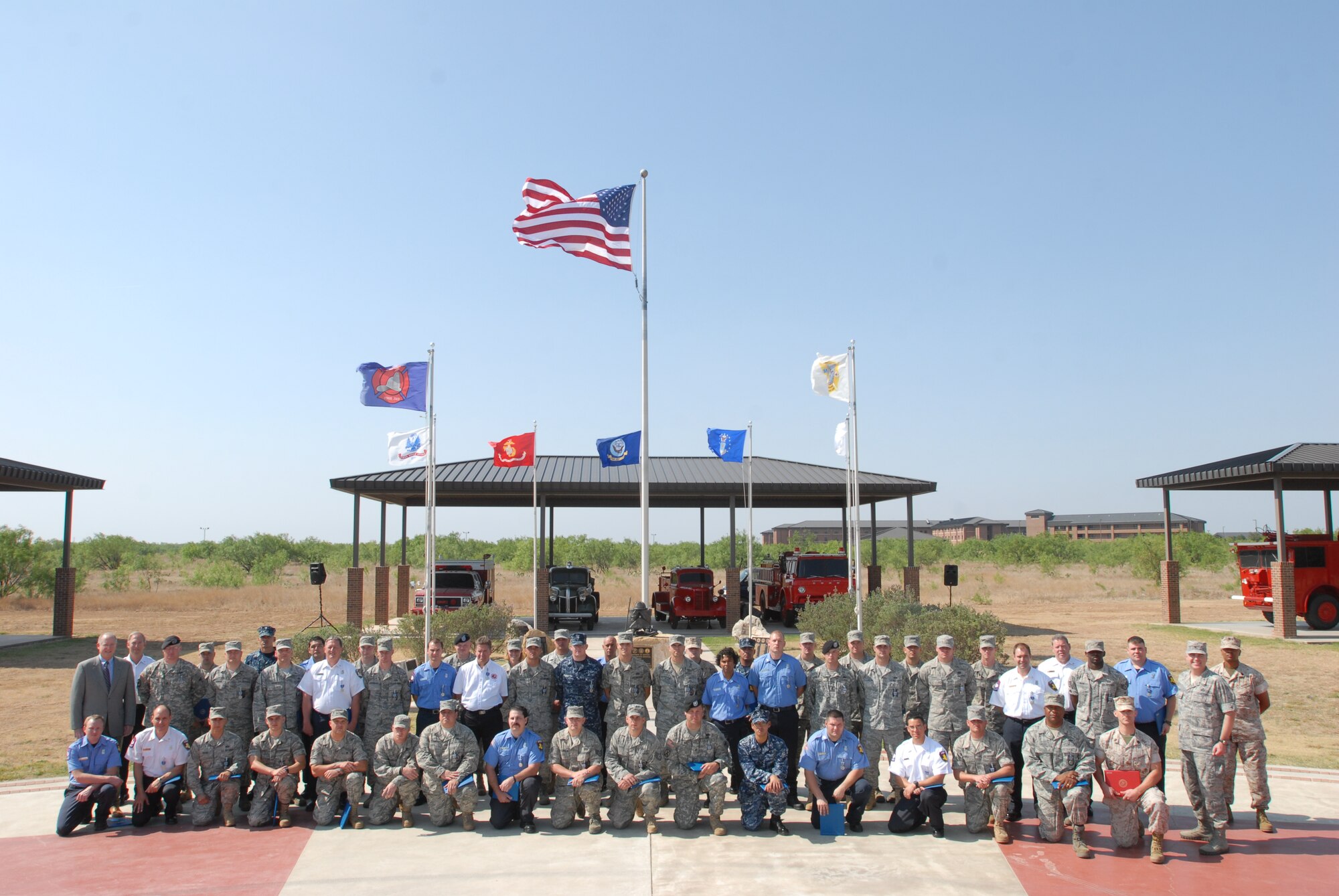 GOODFELLOW AIR FORCE BASE, Texas – Firefighters from team Goodfellow pose for a group photo with Congressman Mike Conaway, 11th District of Texas, and Col. Thomas Geary, 17th Training Wing Commander, May 18 after receiving  achievement medals for helping with the Texas Wildcat Fire. (U.S. Air Force photo/Airman 1st Class Michael Smith)
