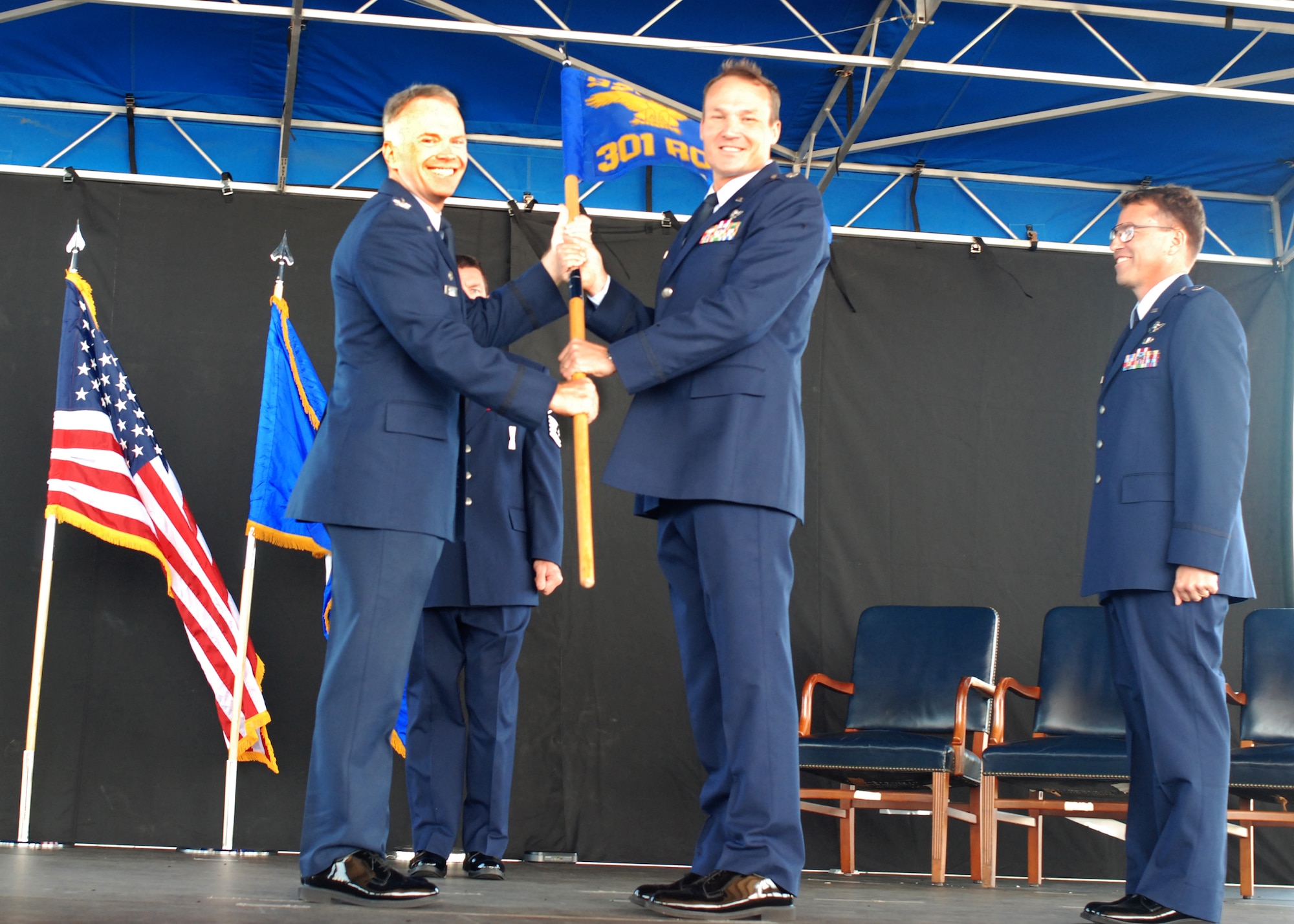 PATRICK AIR FORCE BASE, Fla. - Colonel Christopher Hannon, 920th Rescue Wing Operations Group Commander, hands the 301st Rescue Squadron flag over to its new commander, Lt. Col. Joseph Alcorn during his assumption of command May 19. The 301st RQW is a helicopter squadron which falls under the 920th Rescue Wing - a combat search and rescue unit dedicated to rescuing service members off the battlefield during combat using the HH-60G Pave Hawk helicopter. The Rescue Airmen are also responsible for saving civilians in distress and providing rescue support for the NASA shuttle launches. (U.S. Air Force photo/Staff Sgt. Leslie Forshaw)