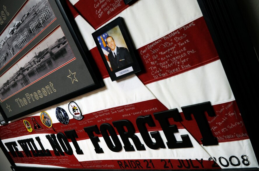 Maj. Mark Brown, who was assigned to the 96th Bomb Squadron in 2008, draped a flag memorial for the fallen aircrew of RAIDR 21 to honor and remember them. RAIDR 21 was the call sign of a B-52H from Barksdale Air Force Base, La., which tragically crashed off the coast of Guam July 21, 2008, killing the six aircrew. (U.S. Air Force photo/Staff Sgt. John Gordinier)(RELEASED)