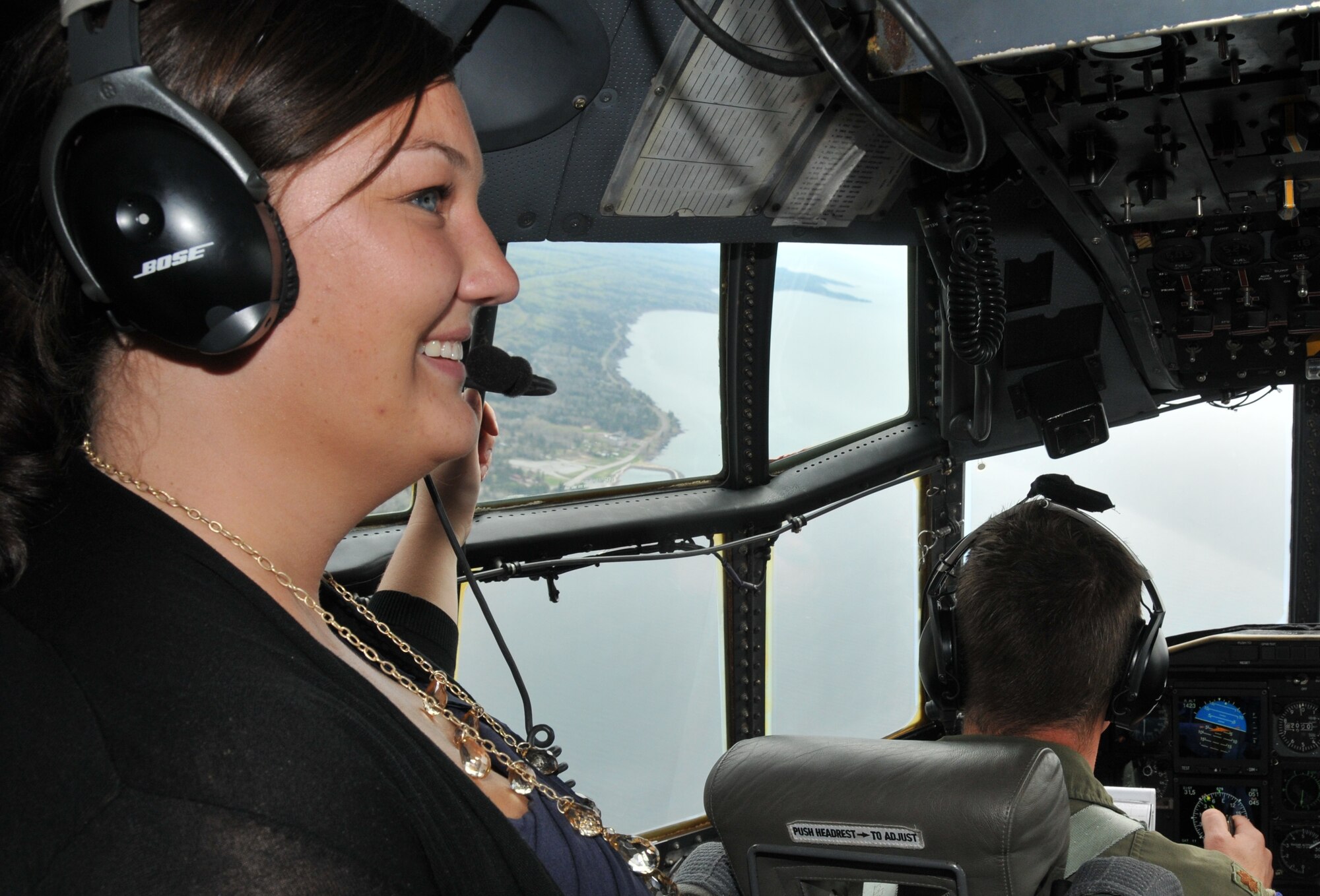 Callie Wahl, staffer for Congressman Chip Cravaack, enjoys the view from a 934th Airlift Wing C-130 over Duluth during the congressional staffer flight May 19. (Air Force Photo/Paul Zadach)