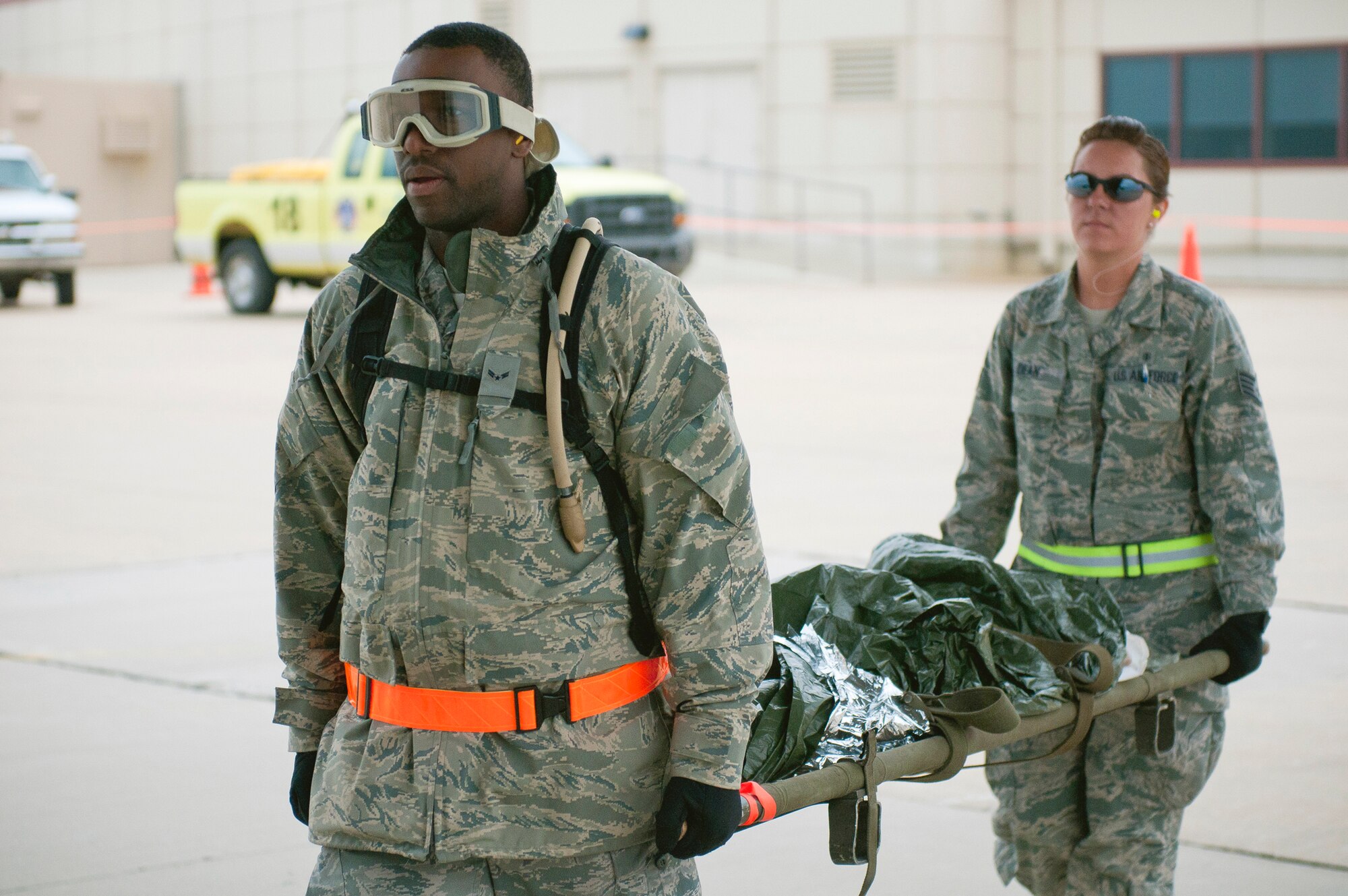 Airman 1st Class Renaldo Maxwell and Staff Sgt. Stephanie Dean carry a mannequin into the back of a C-130 Hercules May 18, 2011, at Springfield-Branson National Airport in Springfield, Mo., as part of National Level Exercise 2011. The exercise is based on a scenario involving an earthquake, requiring aeromedical evacuation of injured patients. Airman Maxwell is assigned to the 6th Medical Group at MacDill Air Force Base, Fla., and Sergeant Dean is assigned to Travis Air Force Base, Calif., (U.S. Air Force photo/Senior Airman Maxwell Rechel) 