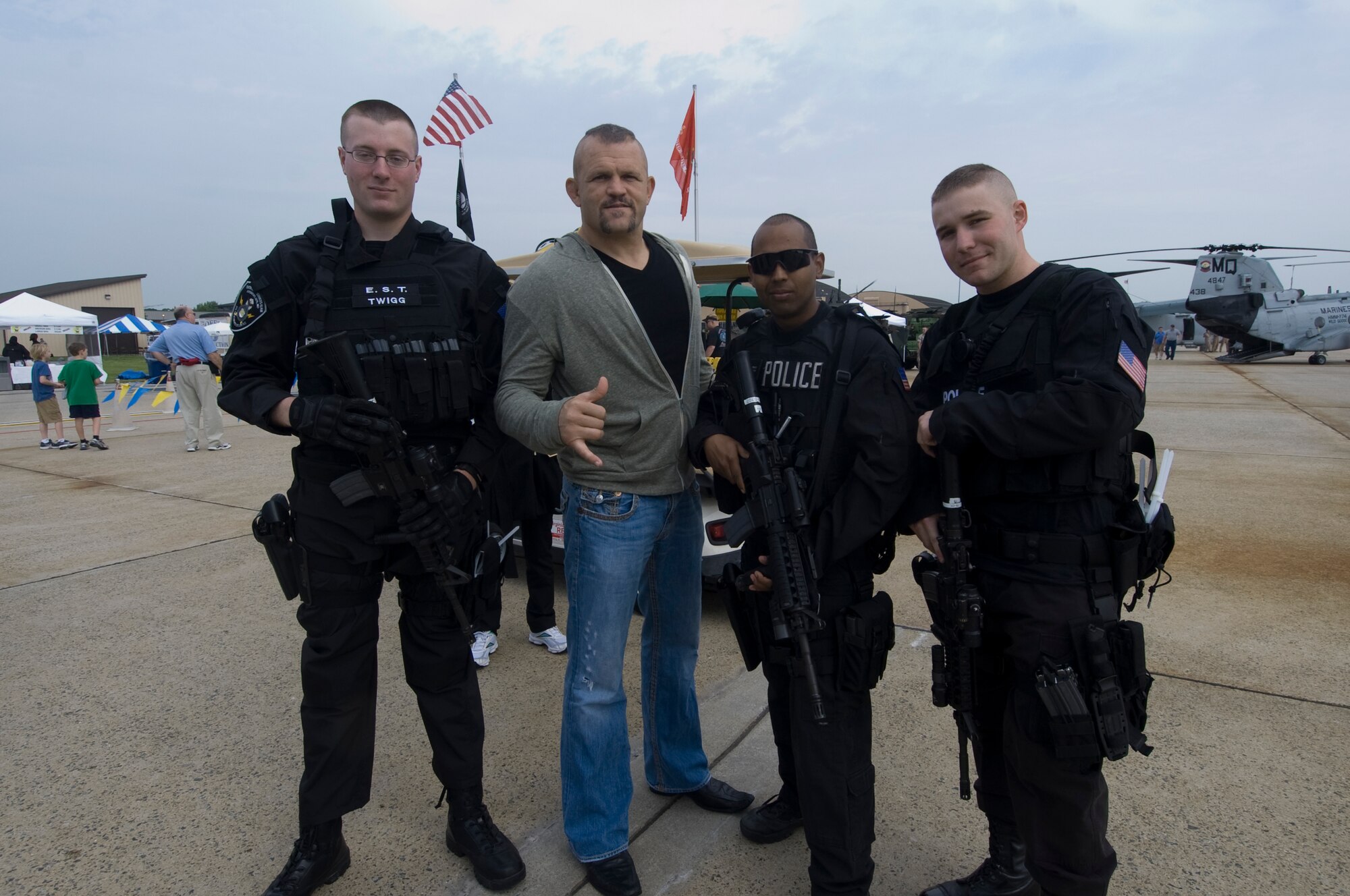 Chuck “the ice man” Lidell, mixed martial arts legend, poses for a photo opportunity with, 11th  Security Forces Squadron members, Senior Airman Gregory Twigg, left, Staff Sgt. Cerrato Oswaldo, center, and Airman 1st Class Pierre Andiffred during the 2011 Joint Service Open House here. JSOH affords the public an opportunity to meet the men and women of the Armed Forces and to see military equipment from the Navy, Marines, Army, Air Force, and Coast Guard.  JSOH is planned and conducted through the efforts of active duty, guard and reserve service members, as well as civilian employees, retirees and family members. (Photo by Bobby Jones)