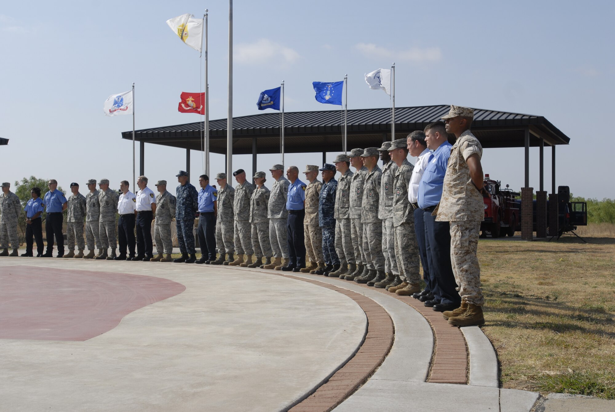 GOODFELLOW AIR FORCE BASE, Texas -- Team Goodfellow firefighters stand at parade rest during a ceremony at the Department of Defense Fallen Firefighter Heritage Memorial here May 18. Achievement medals were presented to 54 Team Goodfellow firefighters by Col. Thomas Geary, 17th Training Wing Commander, and Congressman Mike Conaway, 11th District of Texas, in recognition of their efforts fighting the Wildcat Fire, which burned nearly 160,000 acres. (U.S. Air Force photo/Lou Czarnecki)