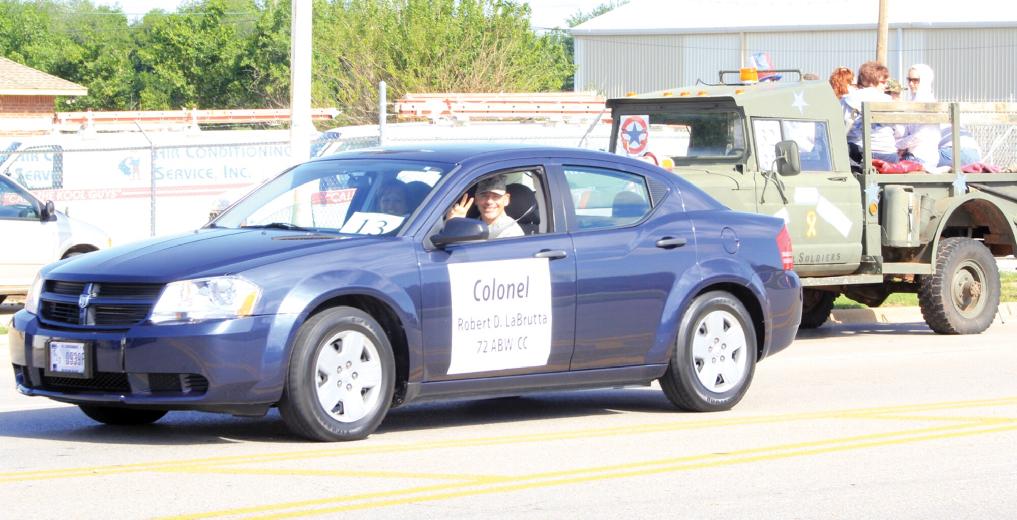 Col. Bob LaBrutta, 72nd Air Base Wing and Tinker installation commander, waves from his car in the Del City Armed Forces Day parade on Sunnylane Road, May 16. The annual parade featured many historical military entries, community leaders and local firefighter and law enforcement. 