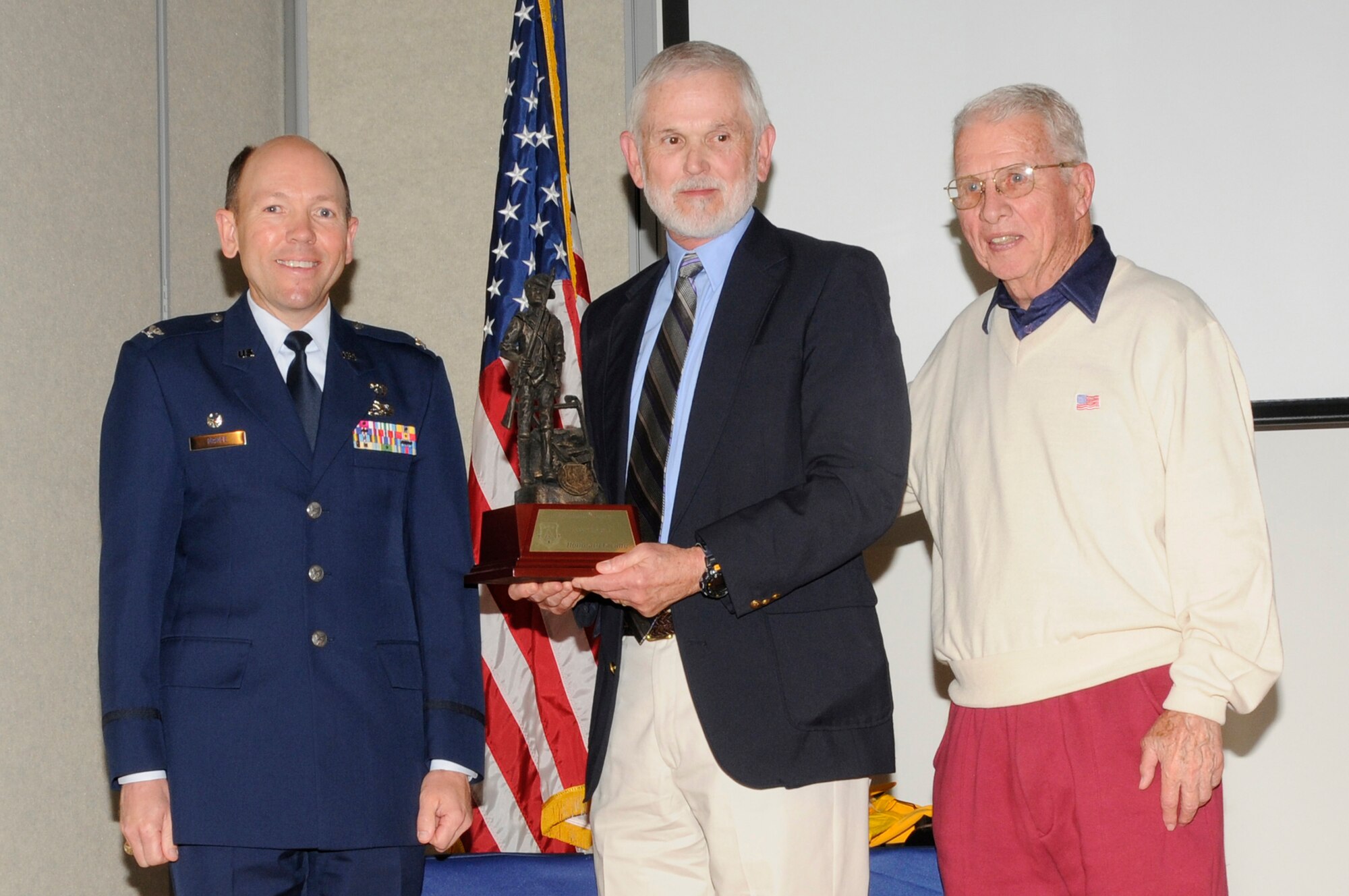 McGHEE TYSON AIR NATIONAL GUARD BASE, Tenn. - Col. Bradley McRee, left, TEC commander, and retired Col. Edmund Morrisey, right, the first TEC commander, present the center's honorary faculty award to retired Col. Russ Gregory, center, for his contributions in 1971 to the Officer Preparatory Academy during a ceremony held in Spruance Hall on the campus of The I.G. Brown Air National Guard Training and Education Center, May 6, 2011.  The event was held on the occasion of the 40th anniversary of the program.  (U.S. Air Force photo by Master Sgt. Kurt Skoglund/released)