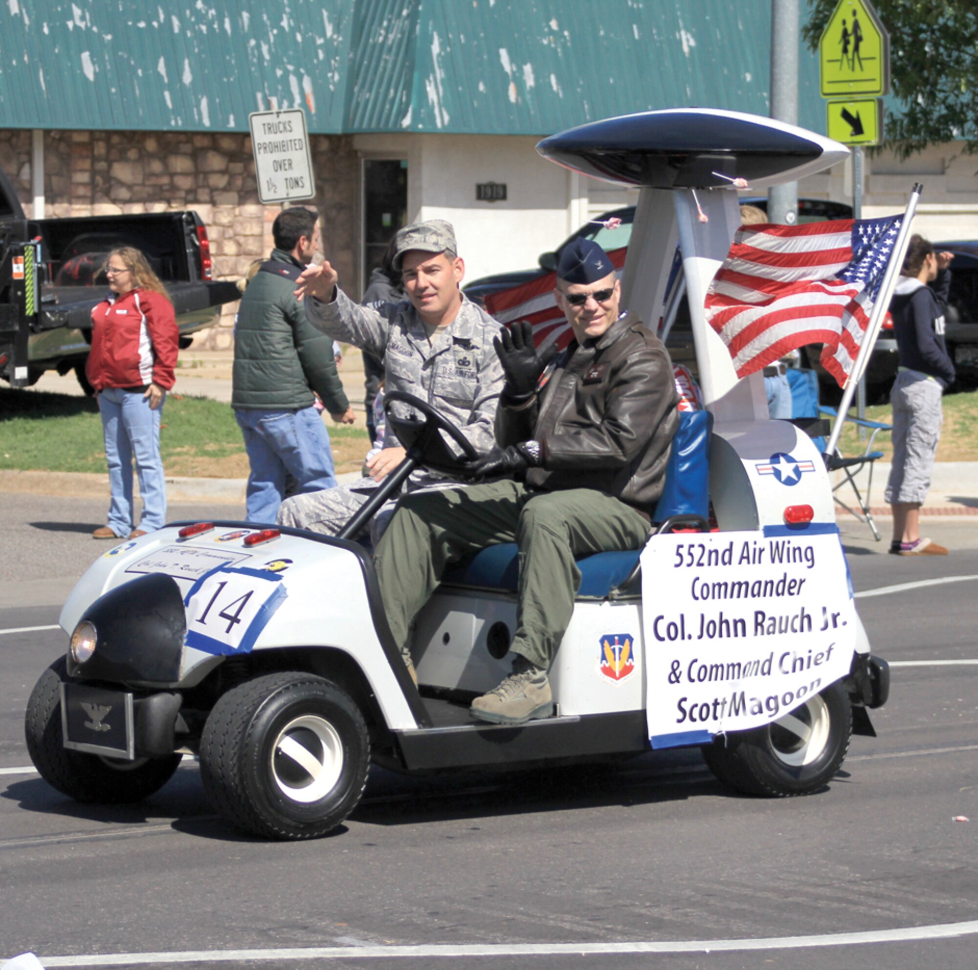 Col. John Rauch, 552nd Air Control Wing commander, driving, and 552nd ACW Command Chief Master Sgt. Scott Magoon tossed candy to parade attendees from the “roto-mobile.” The annual parade featured many historical military entries, community leaders and local firefighter and law enforcement. (Air Force photo by Micah Garbarino)