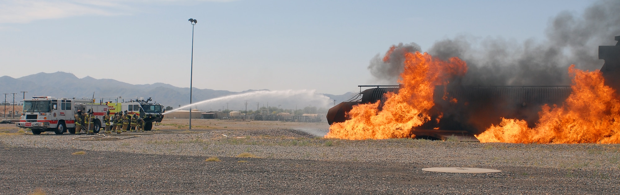 Firefighters from Mesa Fire Department fight a simulated aircraft fire May 4 during live-fire training.  The first training session involved both Mesa and Luke Air Force Base fire departments.  Live-fire training is an annual training requirement for all firefighters.  (U.S. Air Force photo by Senior Airman Tracie Forte)