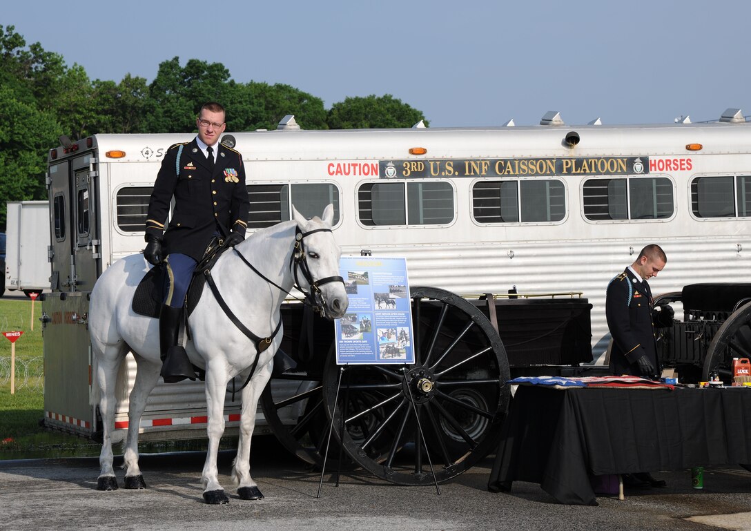 Army Specialist Joseph M. Staples, 3rd U.S. Infantry Caisson Platoon, Fort Meyers, Va., old guard member, stands ready with his horse Babe at the 2011 Joint Service Open House May 20. The 2011 JSOH affords members of the public an opportunity to meet and interact with the men and women of the Armed Forces and to showcase military equipment from the Navy, Marines, Army, Air Force, and Coast Guard. The 2011 JSOH is planned and conducted by active duty, guard, reserve, civilian employees, as well as retirees and family of military members. (U.S. Marine Corps photo)
