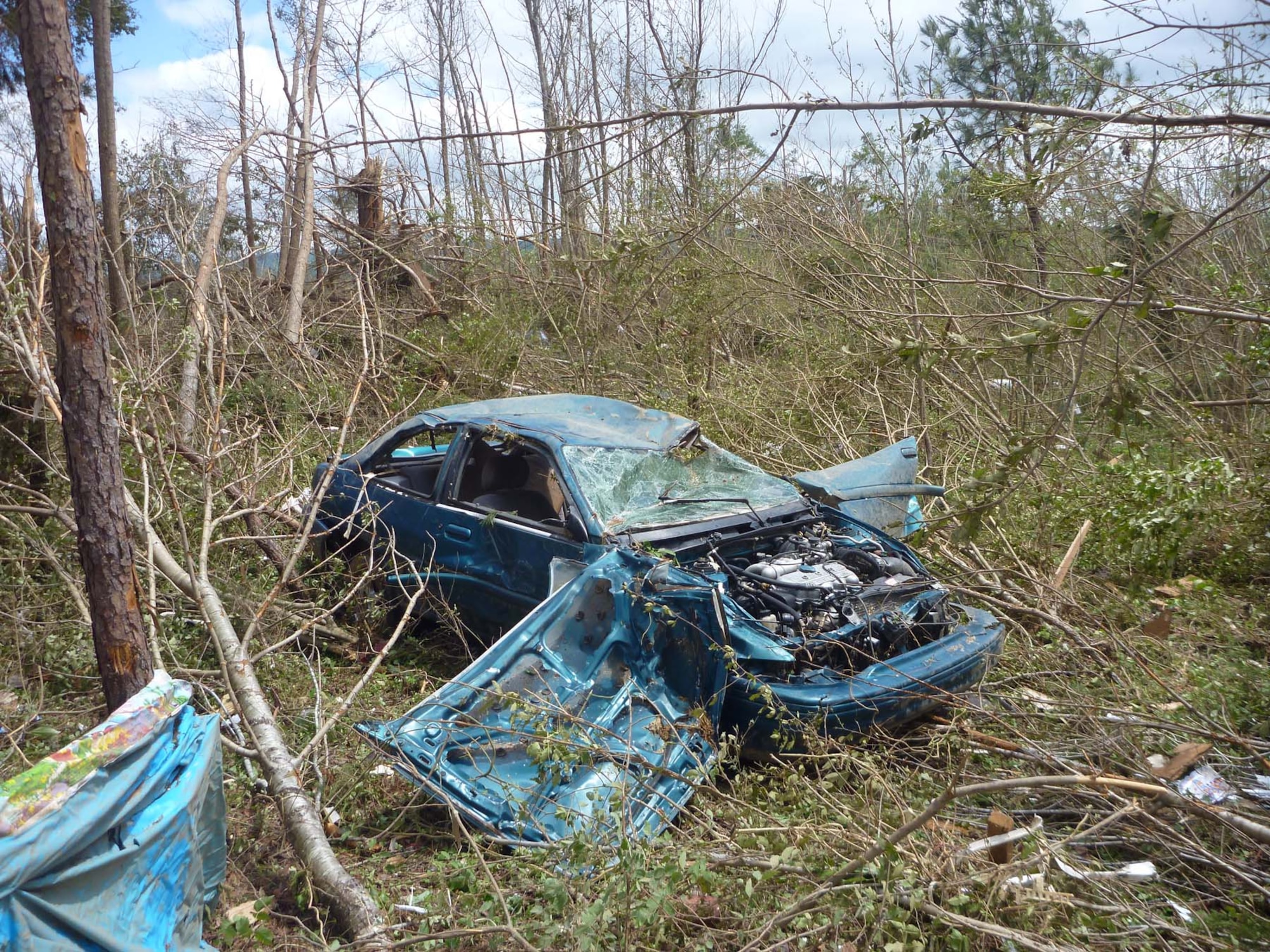 A car that once was parked next to ATA employee Warren Mullinax’s home in Bridgeport, Ala., was found sitting in a row of trees 50 yards away after a tornado destroyed his family’s home April 27. Even though his home was leveled, no one in his family was injured. (Photo provided)