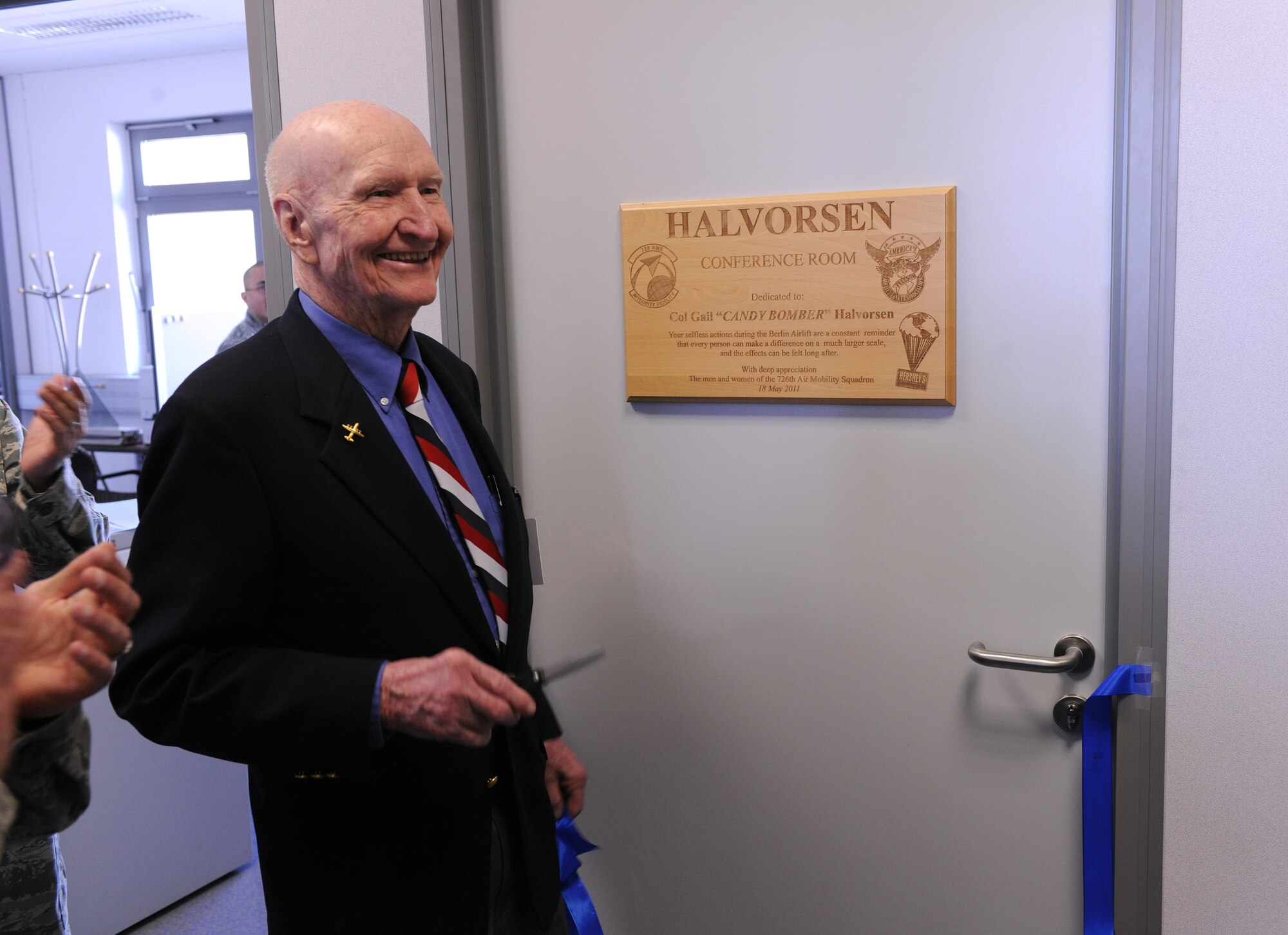 SPANGDAHLEM AIR BASE, Germany – Retired Col. Gail Halvorsen cuts the ribbon for the new Halvorsen conference room at the 726th Air Mobility Squadron during his visit here May 18. Colonel Halvorsen dropped candy to Berlin children from 1947-1948 and earned the nickname “Candy Bomber.” (U.S. Air Force photo/Senior Airman Nathanael Callon)