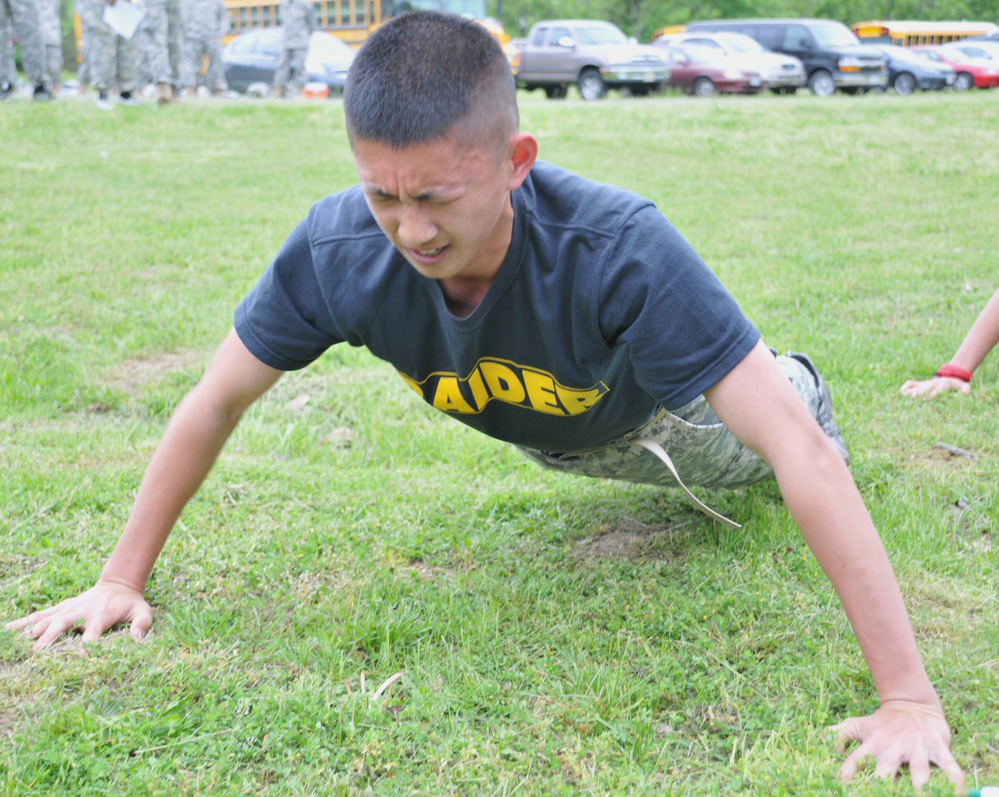 Cadet Charlie Wu, a Junior Reserve Officer Training Corps cadet from Fort Hamilton High School, Brooklyn, N.Y., knocks out another push-up during the Army physical fitness training during the 2011 Raider Competition conducted here May 14. The Raider competition was hosted by the Reserve Officer Training Corps, 2nd Brigade, testing the mental and physical abilities of approximately 130 cadets from 10 regional schools. (U.S. Air Force photo by Pascual Flores/Released)