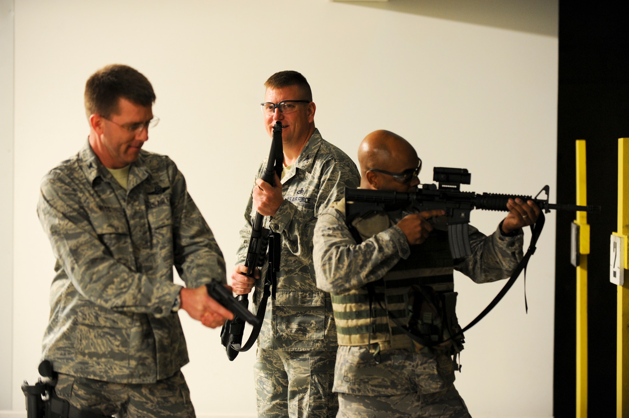 (Left) Col. Steven Hiss, 28th Bomb Wing vice commander, Col. James Katrenak, 28th Maintenance Group commander, and  Col. Trent Edwards, 28th Mission Support Group commander, stack and prepare to engage targets during the “O-6 Shootout” at  Ellsworth Air Force Base, S.D., May 19, 2011. The competition consisted of courses involving the use of M-4s, M-9s and shotguns.   (U.S. Air Force photo/ Senior Airman Adam Grant)