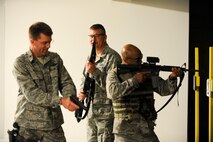 (Left) Col. Steven Hiss, 28th Bomb Wing vice commander, Col. James Katrenak, 28th Maintenance Group commander, and  Col. Trent Edwards, 28th Mission Support Group commander, stack and prepare to engage targets during the “O-6 Shootout” at  Ellsworth Air Force Base, S.D., May 19, 2011. The competition consisted of courses involving the use of M-4s, M-9s and shotguns.   (U.S. Air Force photo/ Senior Airman Adam Grant)