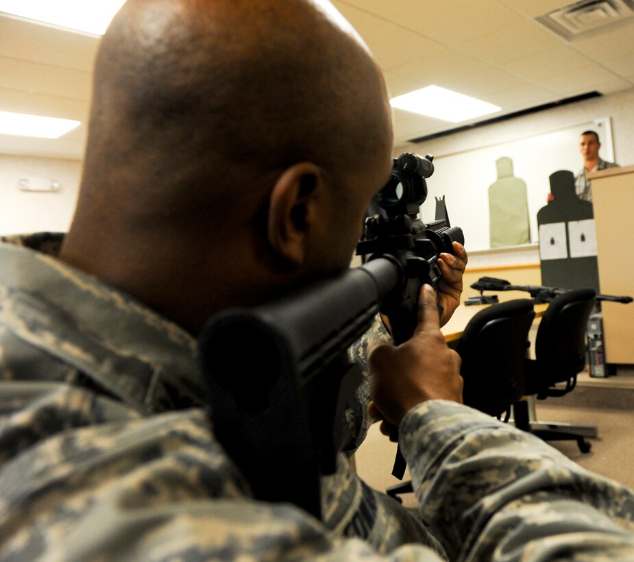 Col. Trent Edwards, 28th Mission Support Group commander, checks his M-4 sight picture before participating in the “O-6 Shootout” competition at Ellsworth Air Force Base, S.D., May19, 2011. The competition was one of a variety of events during National Police Week, a time set aside to recognize military and civilian police professionals for their contributions to the community. (U.S. Air Force photo/ Senior Airman Adam Grant)

