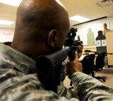 Col. Trent Edwards, 28th Mission Support Group commander, checks his M-4 sight picture before participating in the “O-6 Shootout” competition at Ellsworth Air Force Base, S.D., May19, 2011. The competition was one of a variety of events during National Police Week, a time set aside to recognize military and civilian police professionals for their contributions to the community. (U.S. Air Force photo/ Senior Airman Adam Grant)

