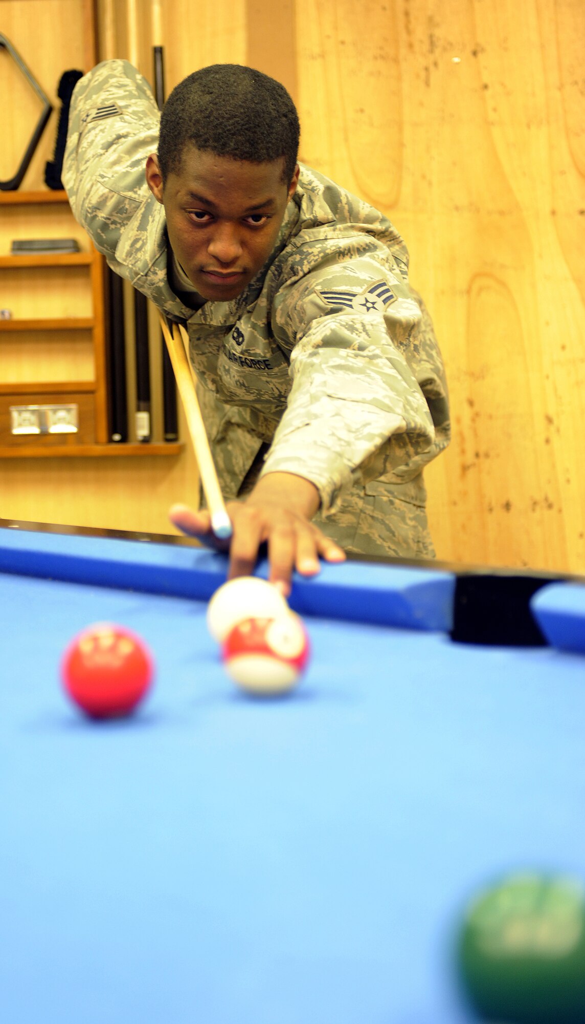 Senior Airman Randy Hubbard plays pool at the military wellness and recreations center?s new location May 20, 2011, at Kandahar Airfield, Afghanistan. The MWR?s new location is much larger filling a prior operations building. Offices were converted into game rooms, call rooms, and offers Wi-Fi through the entire facility. Airman Hubbard is assigned to the 451st Expeditionary Aircraft Maintenance Squadron. (U.S. Air Force photo by Willard E. Grande II)