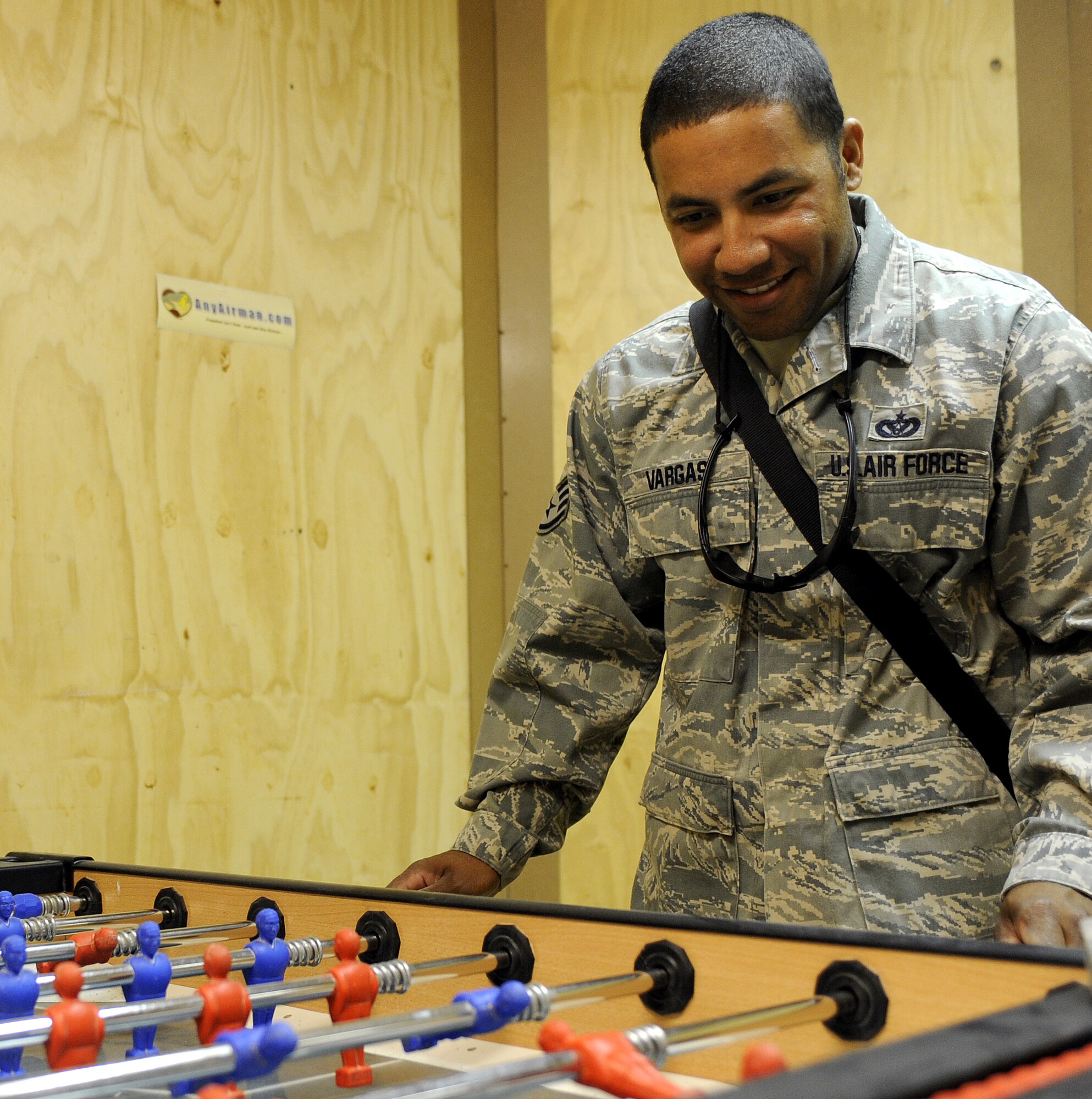 Staff Sgt. Jason Vargas plays foosball at the military wellness and recreations center?s new location May 20, 2011, at Kandahar Airfield, Afghanistan. The MWR?s new location is much larger filling a prior operations building. Offices were converted into game rooms, call rooms, and offers Wi-Fi through the entire facility. Sergeant Vargas is assigned to the 451st Expeditionary Civil Engineer Squadron. (U.S. Air Force photo by Willard E. Grande II)