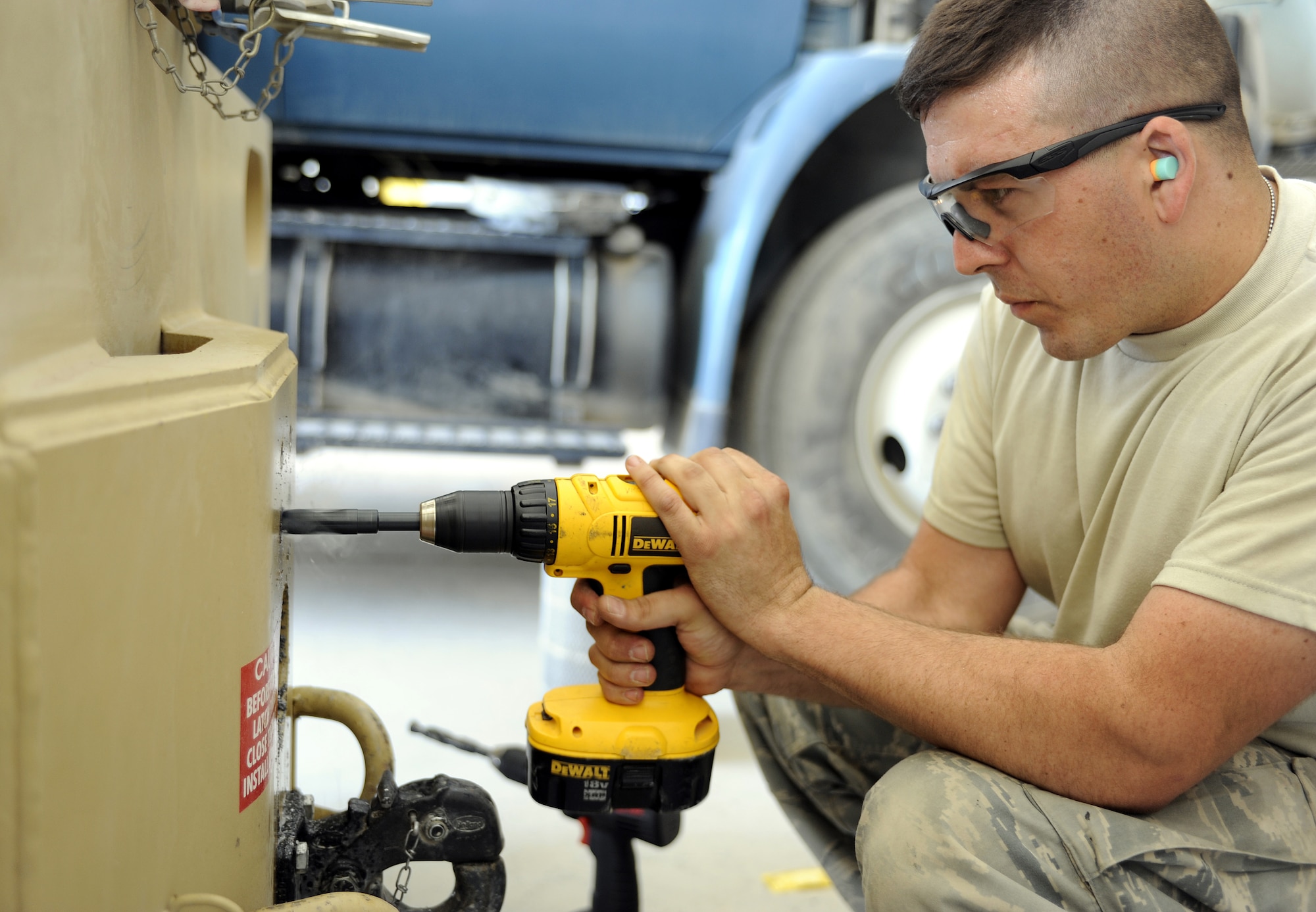 Staff Sgt. Jai Gutierrez drills a hole into a bobcat May 20, 2011, at Kandahar Airfield, Afghanistan. The bobcat is being fitted with a drop pin hitch and must be ventilated to accept the required hardware. Sergeant Gutierrez is the NCO in charge of the main shop assigned to the 451st Expeditionary Vehicle Management Flight. (U.S. Air Force photo by Willard E. Grande II)