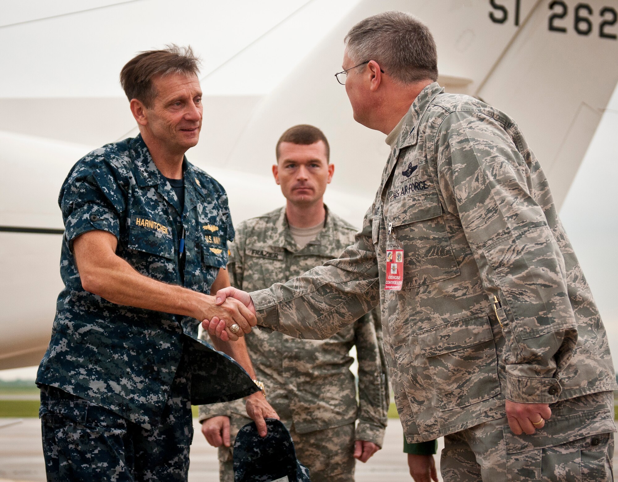 Lt. Col. David Mounkes (right), commander of the Kentucky Air National Guard’s 123rd Contingency Response Element, greets Vice Adm. Mark D. Harnitchek, deputy commander of United States Transportation Command, as he arrives at Springfield-Branson National Airport in Springfield, Mo., on May 19, 2011. Admiral Harnitchek was on hand for a news conference on National Level Exercise 2011, a weeklong training scenario involving a massive earthquake along the New Madrid fault line requiring extensive aeromedical evacuation of injured patients. The Kentucky Air National Guard's 123rd Contingency Response Element was responsible for establishing an initial-response air hub in Springfield during the exercise. (U.S. Air Force photo by Senior Airman Maxwell Rechel)