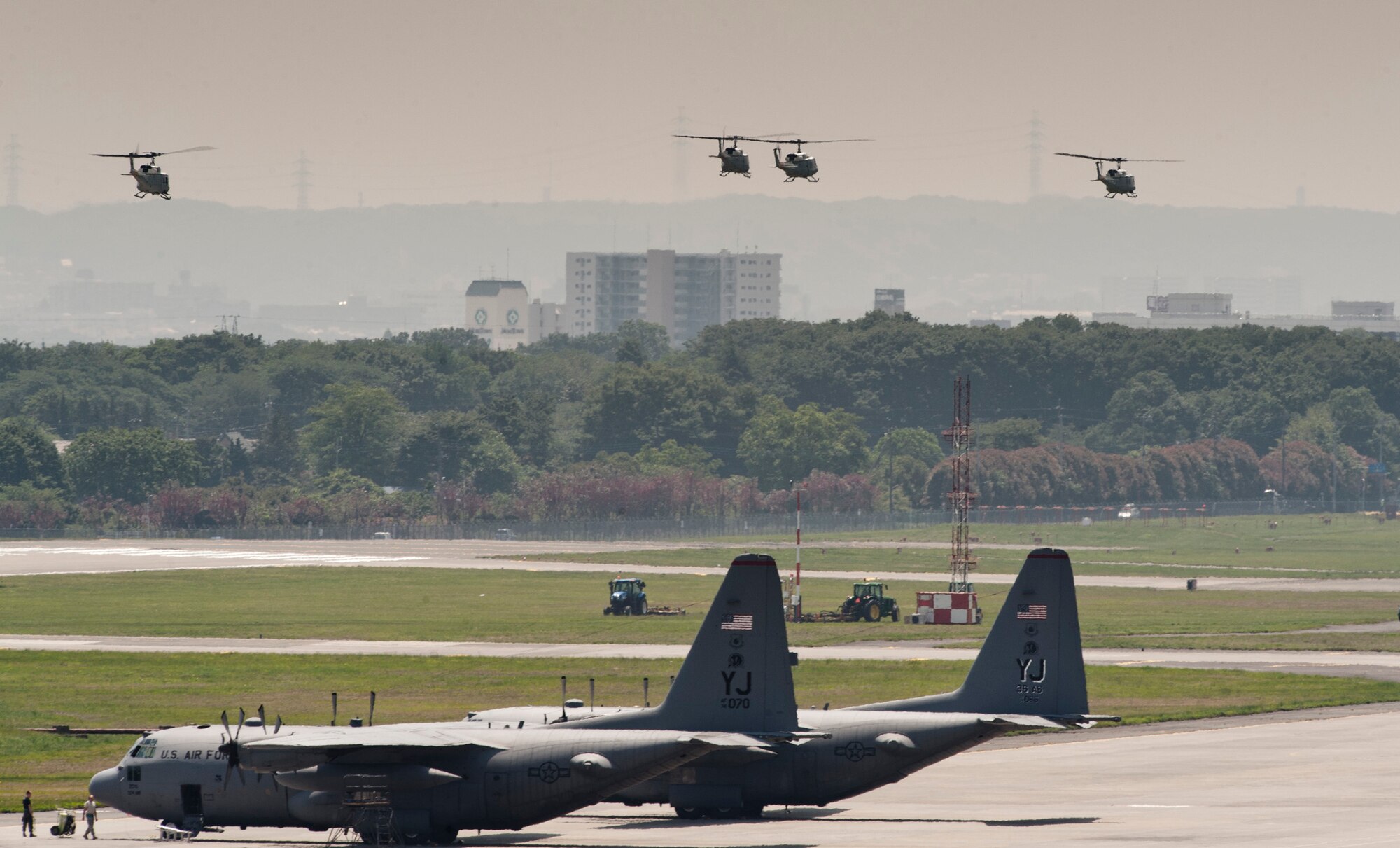 YOKOTA AIR BASE, Japan -- Four UH-1N Iroquois helicopters fly away from Yokota Air Base for a formation flight over southern Japan, May 19, 2011. (U.S. Air Force photo/Staff Sgt. Samuel Morse)