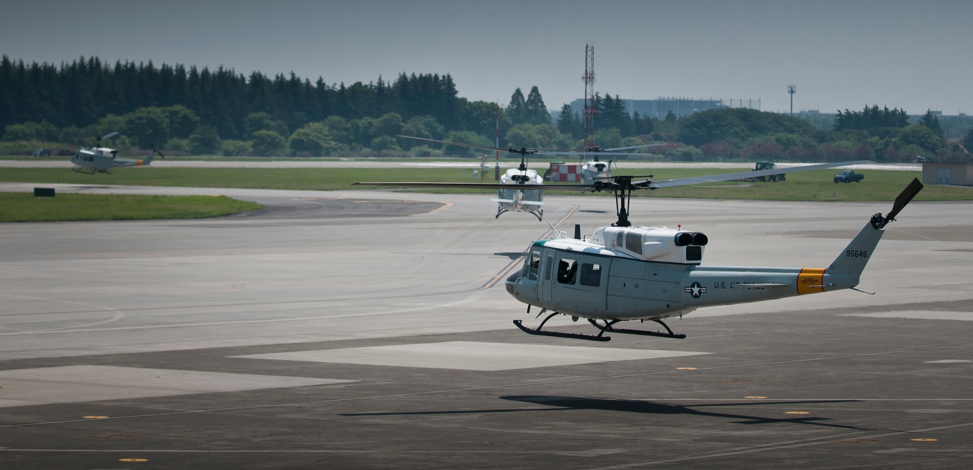 YOKOTA AIR BASE, Japan -- Four UH-1N Iroquois helicopters air-taxi to the Yokota Air Base runway for a formation flight over southern Japan, May 19, 2011. (U.S. Air Force photo/Master Sgt. Kimberly Spinner)