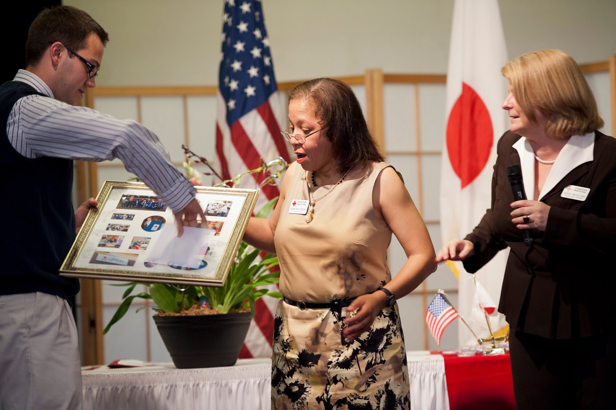 YOKOTA AIR BASE, Japan -- Members of Yokota's American Red Cross station present their station chair, Deidre King-Shepard, with a going away gift during the culmination of the Red Cross Appreciation Dinner at Yokota Air Base, Japan, May 18, 2011. Ms. King-Shepard will take over as regional chair, directing American Red Cross efforts across Japan. (U.S. Air Force photo/Staff Sgt. Samuel Morse)