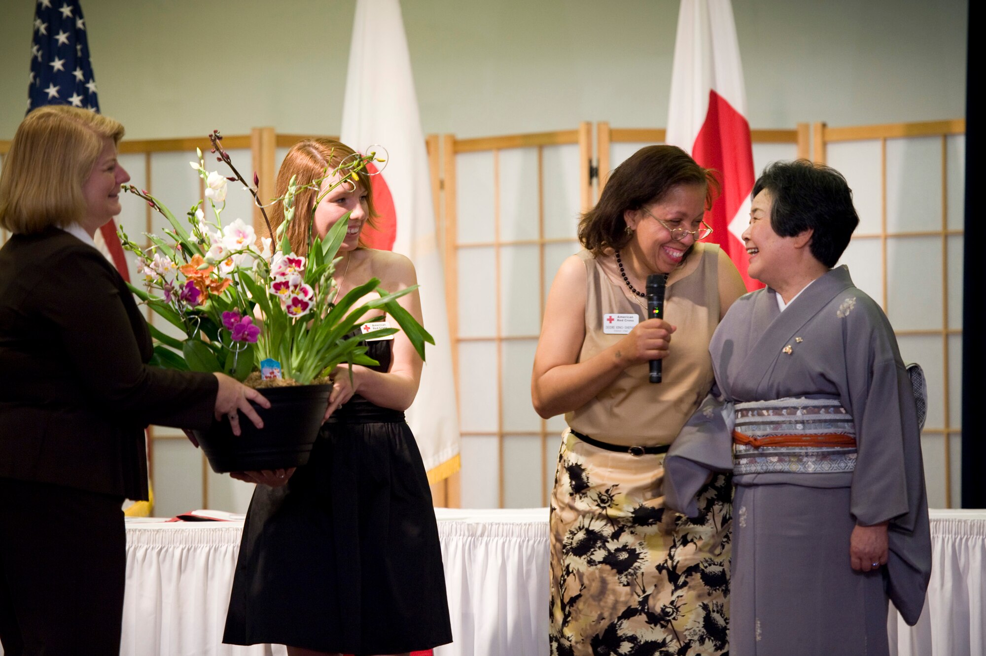 YOKOTA AIR BASE, Japan -- Deidre King-Shepard, Yokota's American Red Cross station chair, presents flowers to Toshiko Tanaka, Akiruno Red Cross chairperson, in celebration and gratitude of the relationship between the two Red Cross organizations during the Red Cross Appreciation Dinner at Yokota Air Base, Japan, May 18, 2011. (U.S. Air Force photo/Staff Sgt. Samuel Morse)