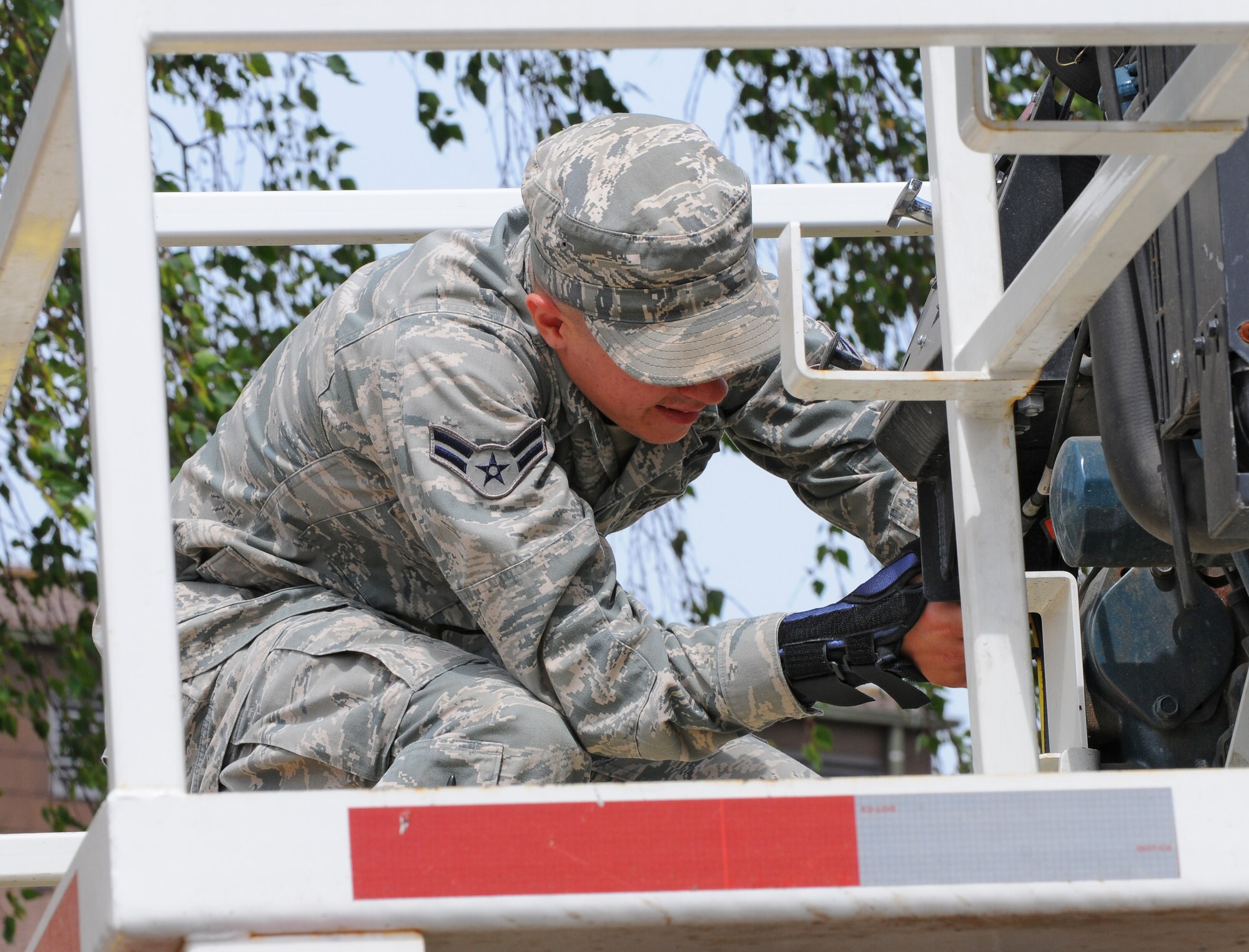 SPANGDAHLEM AIR BASE, Germany – Airman 1st Class Jacob Smith, 52nd Civil Engineer Squadron, adjusts the water flow on a water truck during a barrier plan exercise here May 17. The barrier plan is conducted biannually to ensure Spangdahlem is capable of responding to increased threat levels. (U.S. Air Force photo/Airman 1st Class Dillon Davis)