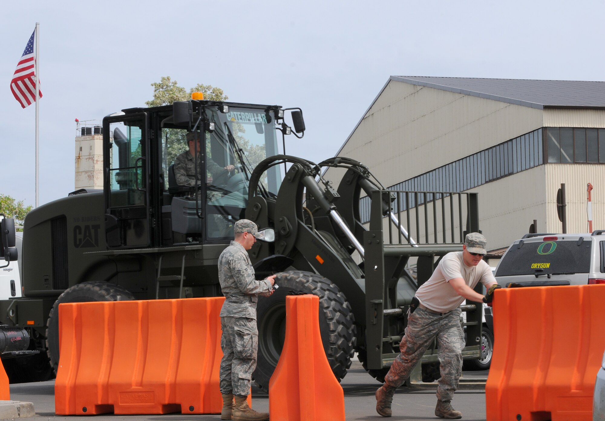 SPANGDAHLEM AIR BASE, Germany – Airmen from the 52nd Civil Engineer Squadron move plastic barriers off a fork lift and into place during a barrier plan exercise here May 17. The barrier plan is conducted biannually to ensure Spangdahlem is capable of responding to increased threat levels. (U.S. Air Force photo/Airman 1st Class Dillon Davis)
