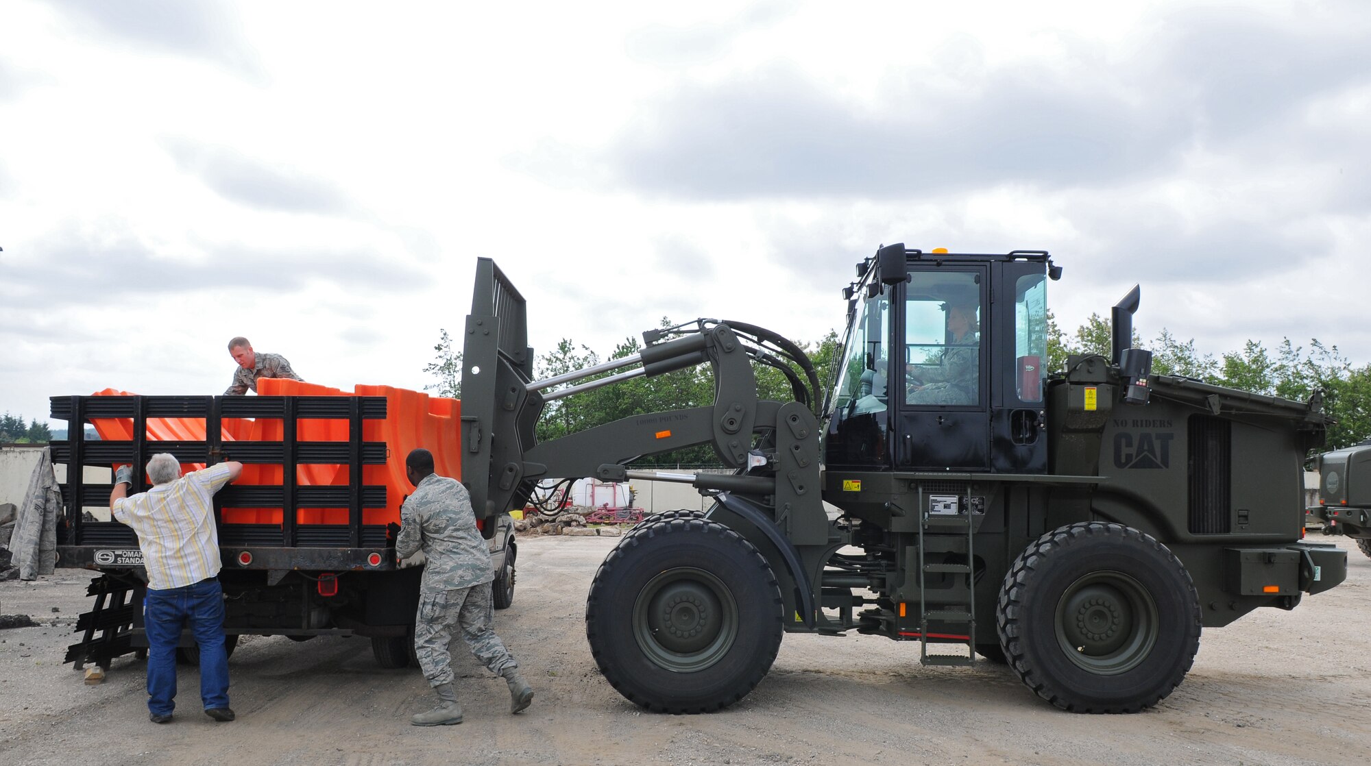SPANGDAHLEM AIR BASE, Germany – Airmen and civilians from the 52nd Logistics Readiness Squadron load barriers onto a transport vehicle during a barrier plan exercise here May 17. The barrier plan is conducted biannually to ensure Spangdahlem is capable of responding to increased threat levels. (U.S. Air Force photo/Airman 1st Class Dillon Davis)