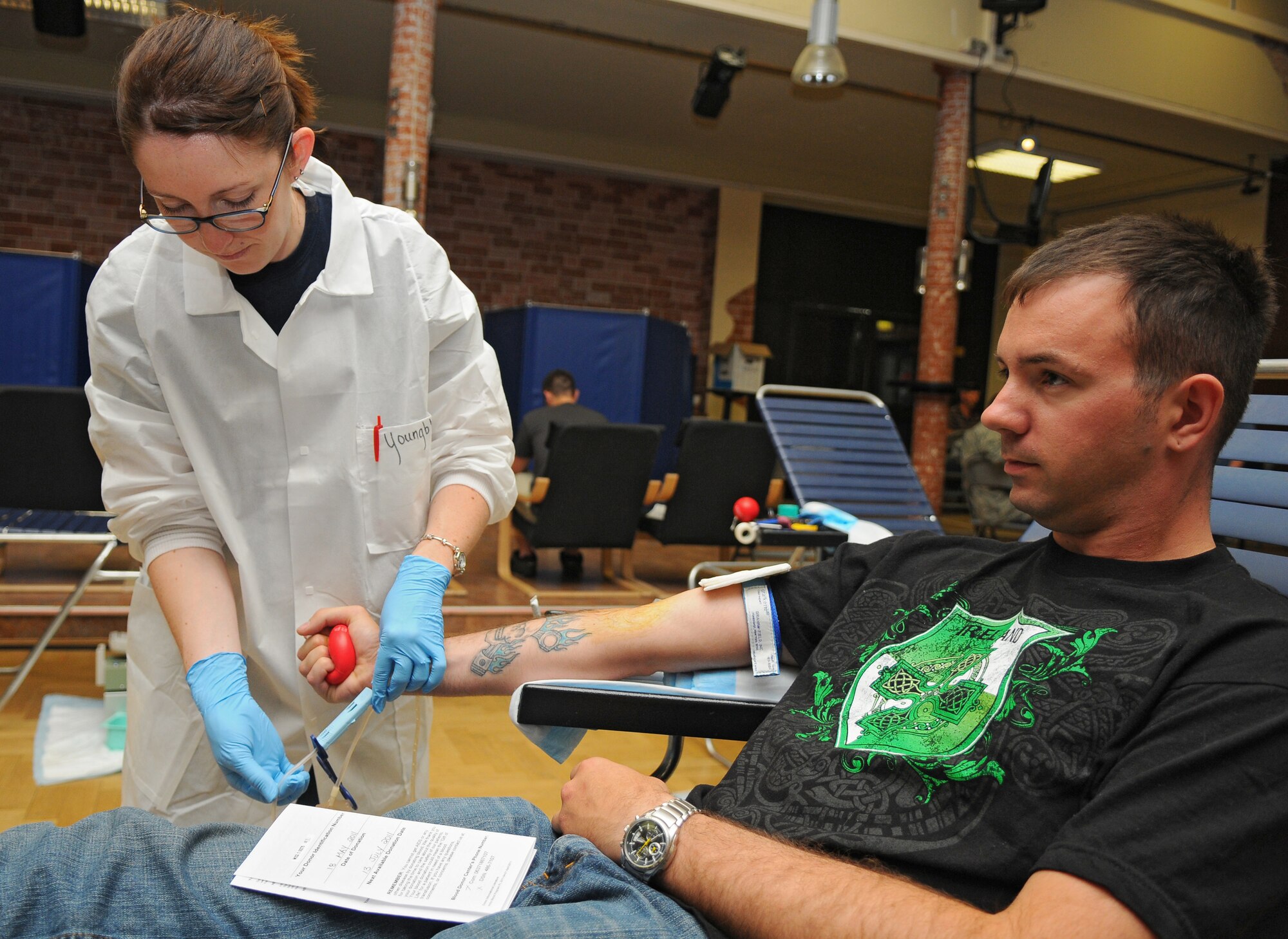 SPANGDAHLEM AIR BASE, Germany – Heather Youngblood, Landstuhl Regional Medical Center phlebotomist, prepares a drawing tube for blood donor Senior Airman Joel Ireland, 726th Air Mobility Squadron, during the Spangdahlem Blood Drive here May 18. The Armed Forces Blood Drive is a worldwide joint operation organized by the Armed Services Blood Program to collect, process, store, distribute, and transfuse blood to many different locations across the globe. (U.S. Air Force photo/Airman 1st Class Dillon Davis)
