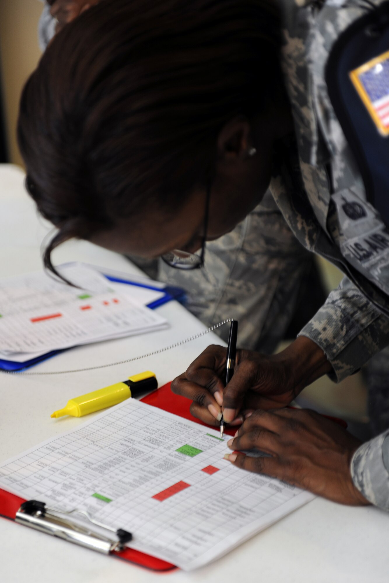 KUNSAN AIR BASE, Republic of Korea -- Tech. Sgt. Ciara Simms, 8th Force Support Squadron lodging section chief, signs in noncombatants during Exercise Courageous Channel here May 19. The exercise is held every spring and organized by the U.S. Forces Korea. It enables U.S. military dependents, non-emergency essential civilians and contractors to walk through the process that would be employed during a noncombatant evacuation. (U.S. Air Force photo/Senior Airman Ciara Wymbs)