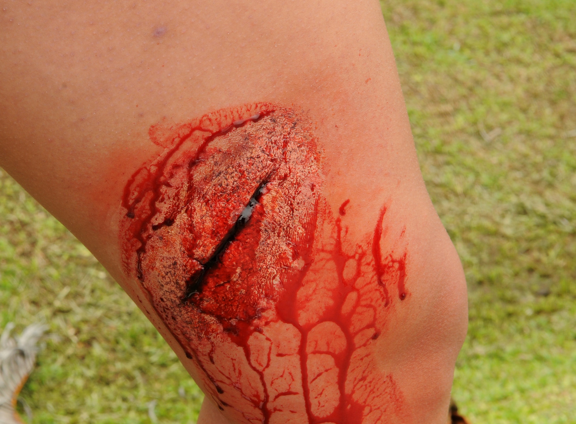 A volunteer plays the part of the victim of a laceration wound after moulage is applied during Beverly High 11-4, a local readiness exercise at Kadena Air Base, Japan, May 19. Moulage is used to simulate severe injuries, adding a heightened degree of reality to emergency situations. (U.S. Air Force photo/Airman 1st Class Jarvie Z. Wallace)
