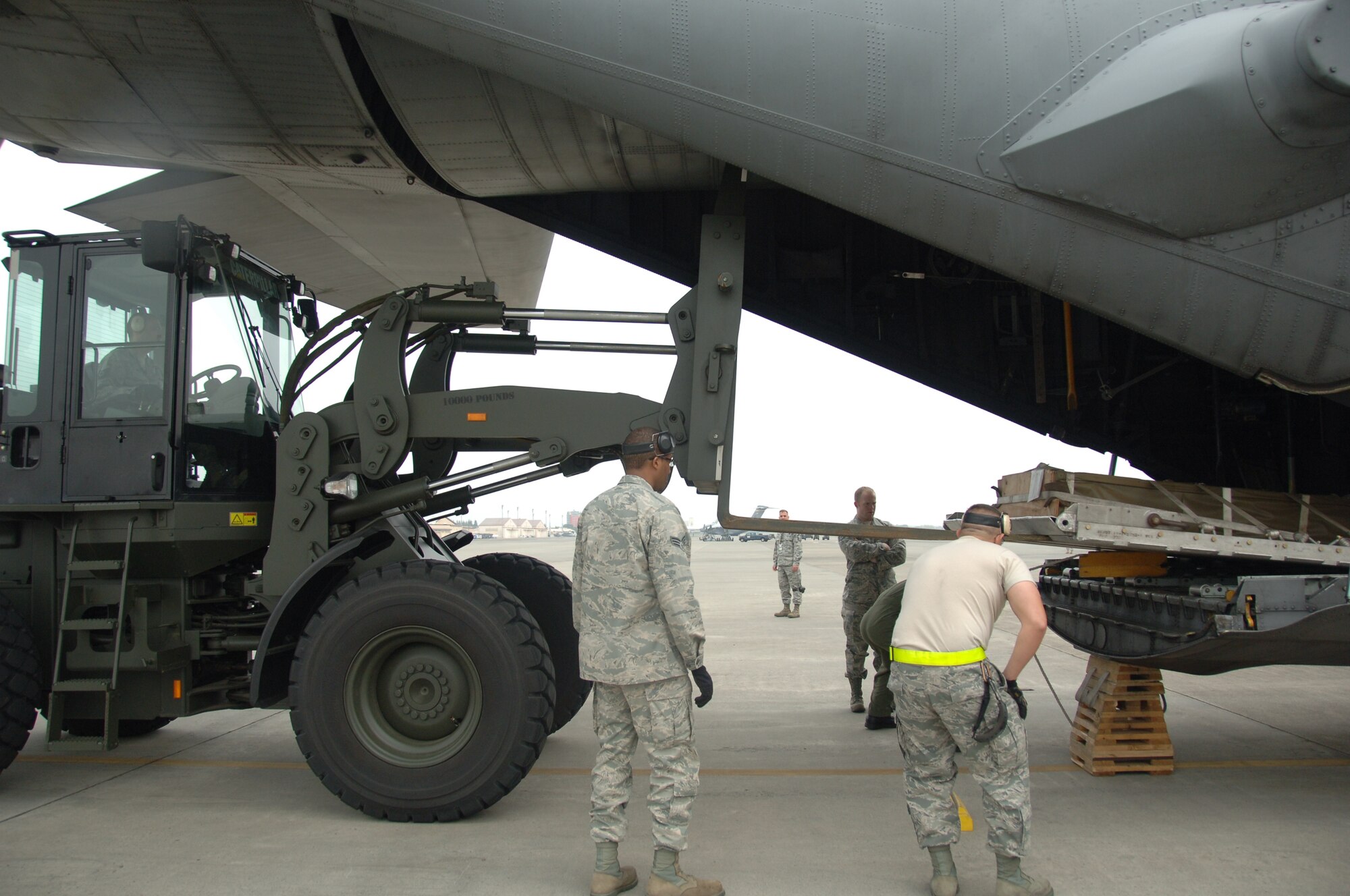 YOKOTA AIR BASE, Japan -- Air transportation craftsmen from the 36th Airlift Squadron work together to load a cargo pallet onto a C-130 plane here at Yokota May 17 during a practice run for the upcoming Air Mobility Command Rodeo. Joint base Lewis-McCord, Washington hosts the competition every two years to generate 'esprit de corps' and promote professionalism among and provide recognition for aircrews, maintenance, aerial port and security forces personnel. (U.S. Air Force photo/Airman 1st Class Lynsie Nichols)