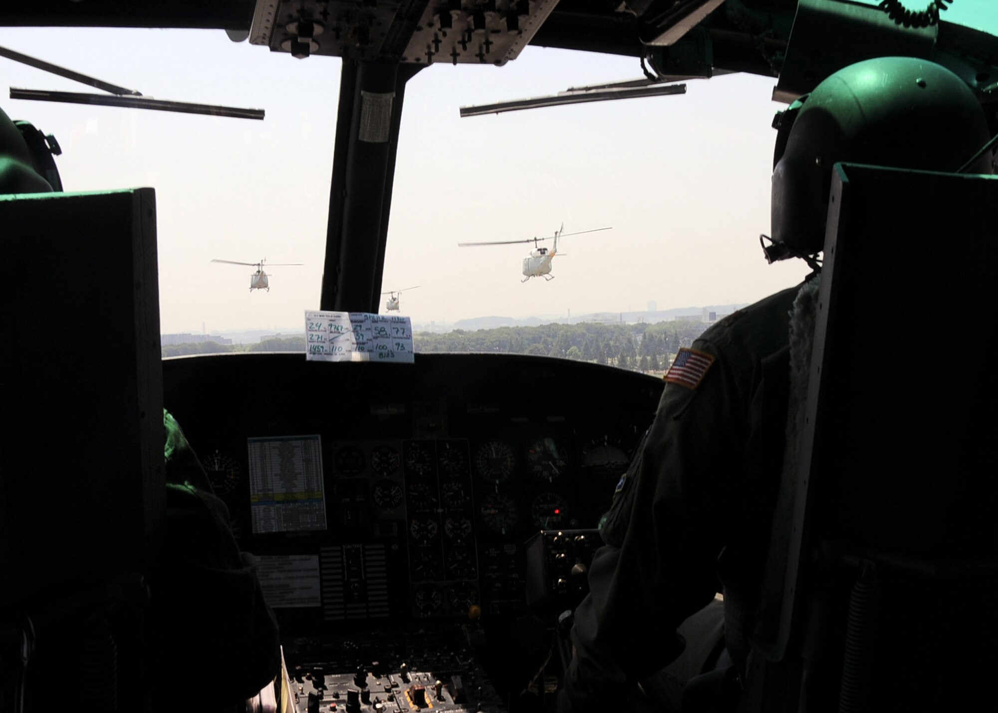 YOKOTA AIR BASE, Japan -- Maj. Destry Hill, 374th Operations Group pilot and 1st Lt. Sean Abling, 459th Airlift Squadron co-pilot, fly in formation behind three other UH-1N Iroquois helicopters, over Yokota Air Base, Japan, May 19, 2011. The formation flight was an opportunity for Yokota to get a glimpse of the raw beauty and power that these 42-year-old war relics still portray said Staff Sgt. Christopher Rector, 459th Airlift Squadron flight engineer.  It also showcased our maintenance and the pride we take in knowing they can keep our wing fully ready to accomplish the mission on any given day. This was the first time since 2002 that all four of Yokota's "Hueys," flew together. (U.S. Air Force photo/Senior Airman Andrea Salazar)