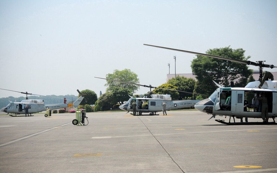 YOKOTA AIR BASE, Japan -- Yokota members prepare the base's UH-1N Iroquois helicopters, often called "Hueys," for a four-ship formation flight at Yokota Air Base, Japan, May 19, 2011. Maintenance and aircrew members worked together to help make the Huey formation flight a successful mission. (U.S. Air Force photo/Senior Airman Andrea Salazar)