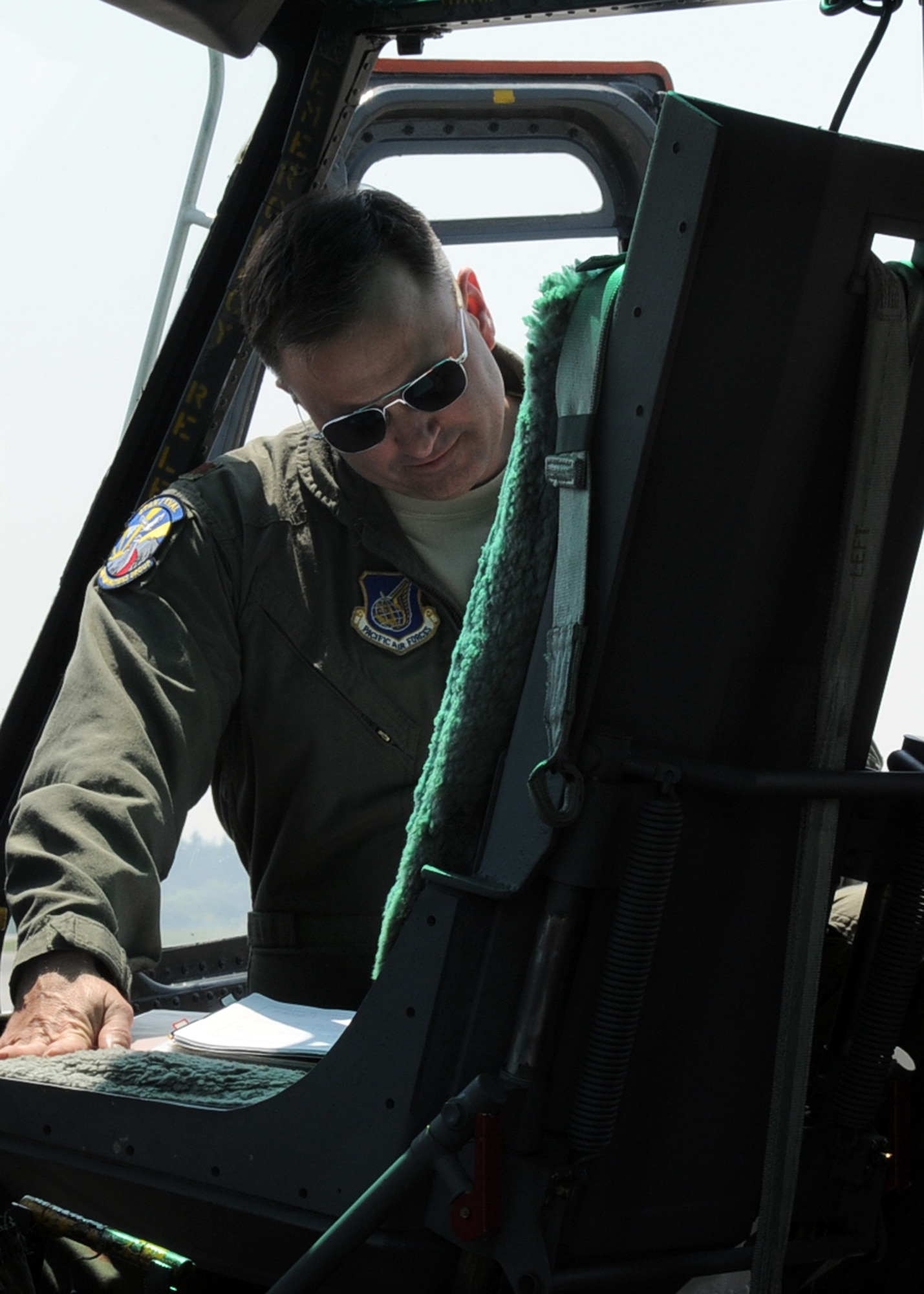 YOKOTA AIR BASE, Japan -- Maj. Destry Hill, 374th Operations Group pilot, looks over mission paperwork prior to piloting a UH-1N Iroquois helicopter for a four-ship formation "Huey" flight, at Yokota Air Base, Japan, May 19, 2011. Major Hill is a Bronze Star Medal recipient and was one of the first Americans at ground zero of coastal Japan after the earthquake and tsunami disaster. (U.S. Air Force photo/Senior Airman Andrea Salazar)