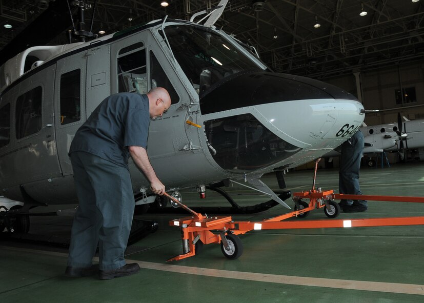 YOKOTA AIR BASE, Japan -- Jason Turk, 374th Maintenance Operations Squadron maintenance technician, prepares a UH-1N Iroquois helicopter for preflight inspections at Yokota Air Base, Japan, May 19, 2011. Yokota members worked together to make a successful formation flight. (U.S. Air Force photo/Senior Airman Andrea Salazar)