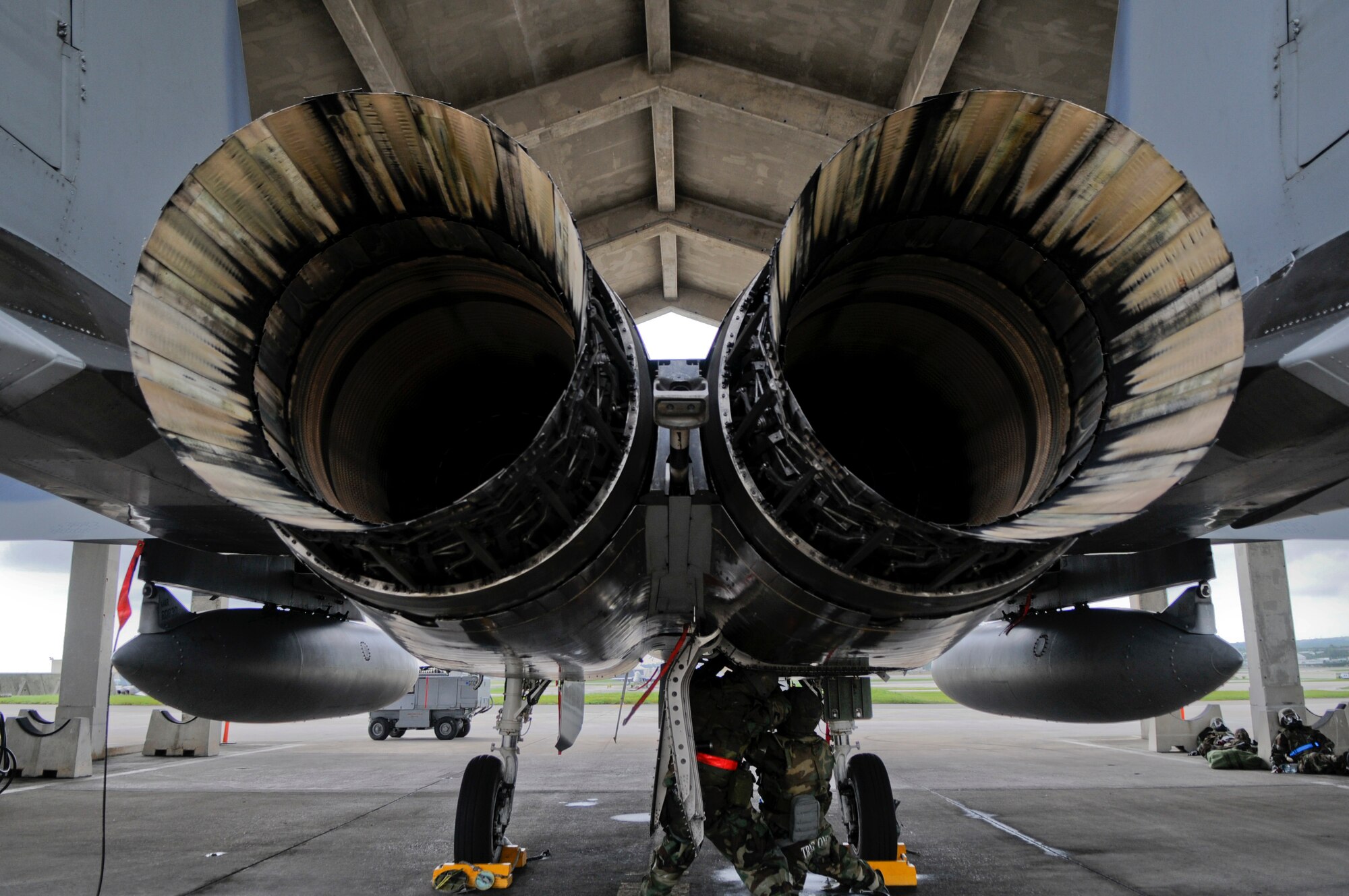 Senior Airman Tyler Disney (left) and Airman 1st Class Jesus Gotay-Rivera, both aerospace propulsion technicians, work on a Kadena F-15 Eagle’s propulsion systems while in mission-oriented protective posture gear during Beverly High 11-4, a local operational readiness exercise, on Kadena Air Base, May 19. During a LORE, Airman must continue to perform their normal duties despite participating in a series of attack scenarios that test their survival and operation capabilities. Airman Gotay-Rivera is from the 67th Aircraft Maintenance Unit, and Airman Disney is from the 44th AMU. (U.S. Air Force photo/ Airman 1st Class Maeson L. Elleman)