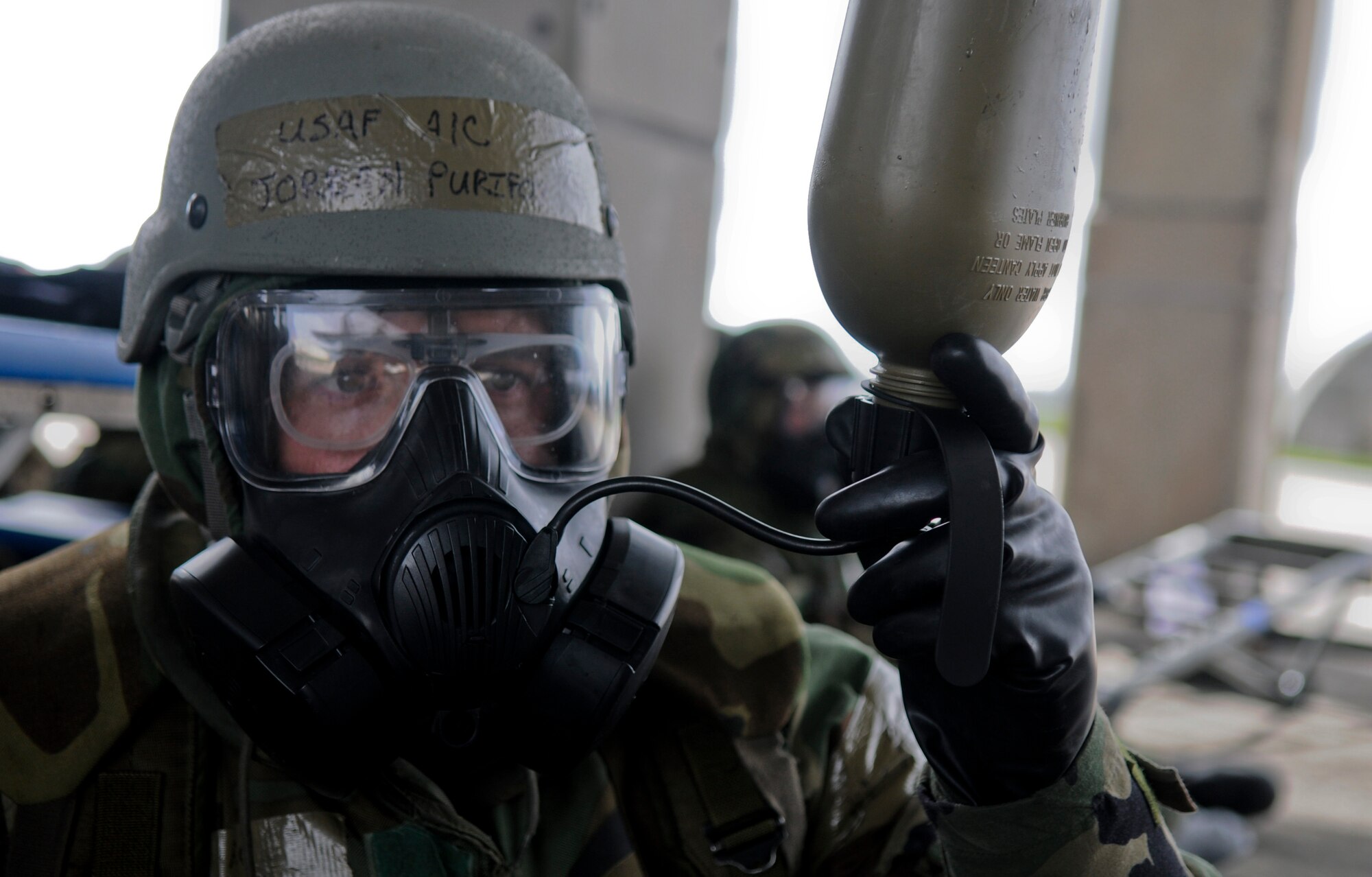 Airman 1st Class Jordan Purifoy, 18th Aircraft Maintenance Squadron, drinks from his canteen to stay hydrated while in his mission-oriented protective posture gear during Beverly High 11-4, a local operational readiness exercise, on Kadena Air Base, May 19. During the LORE, Airmen were expected to perform and operate in numerous scenarios from power outages and minor on-the-job injuries, to bomb threats, chemical and aerial attacks. (U.S. Air Force photo/ Airman 1st Class Maeson L. Elleman)