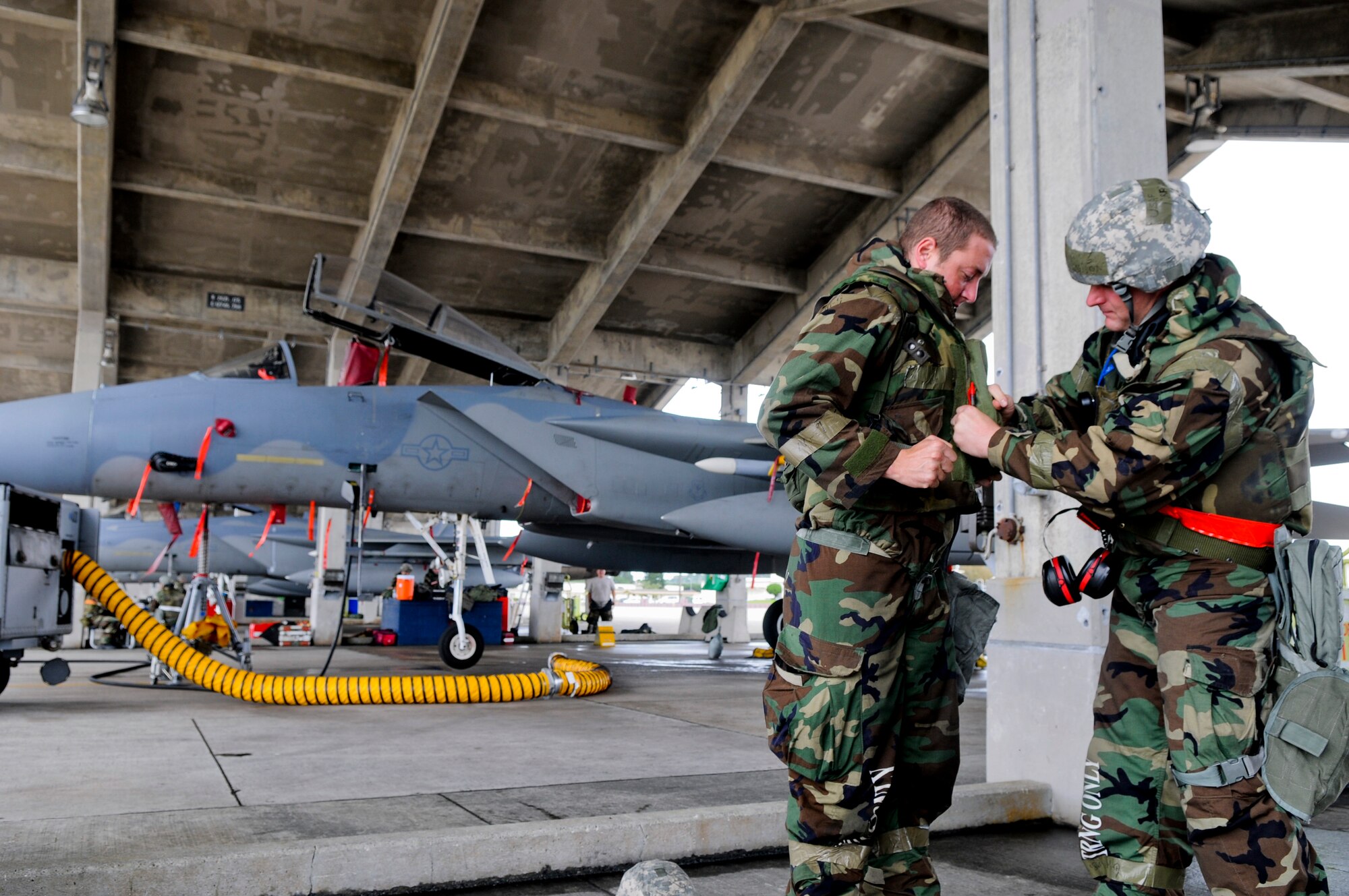 Master Sgt. Craig Larson, 67th Aircraft Maintenance Unit production superintendent (right), performs a buddy check on Senior Airman Kyle Dallaire, 67th AMU crew chief, during Beverly High 11-4, a local operational readiness exercise, on Kadena Air Base, May 19. The LORE tested Airmen’s ability to operate in a multitude of attack scenarios, preparing them for future real-world contingencies. (U.S. Air Force photo/ Airman 1st Class Maeson L. Elleman)
